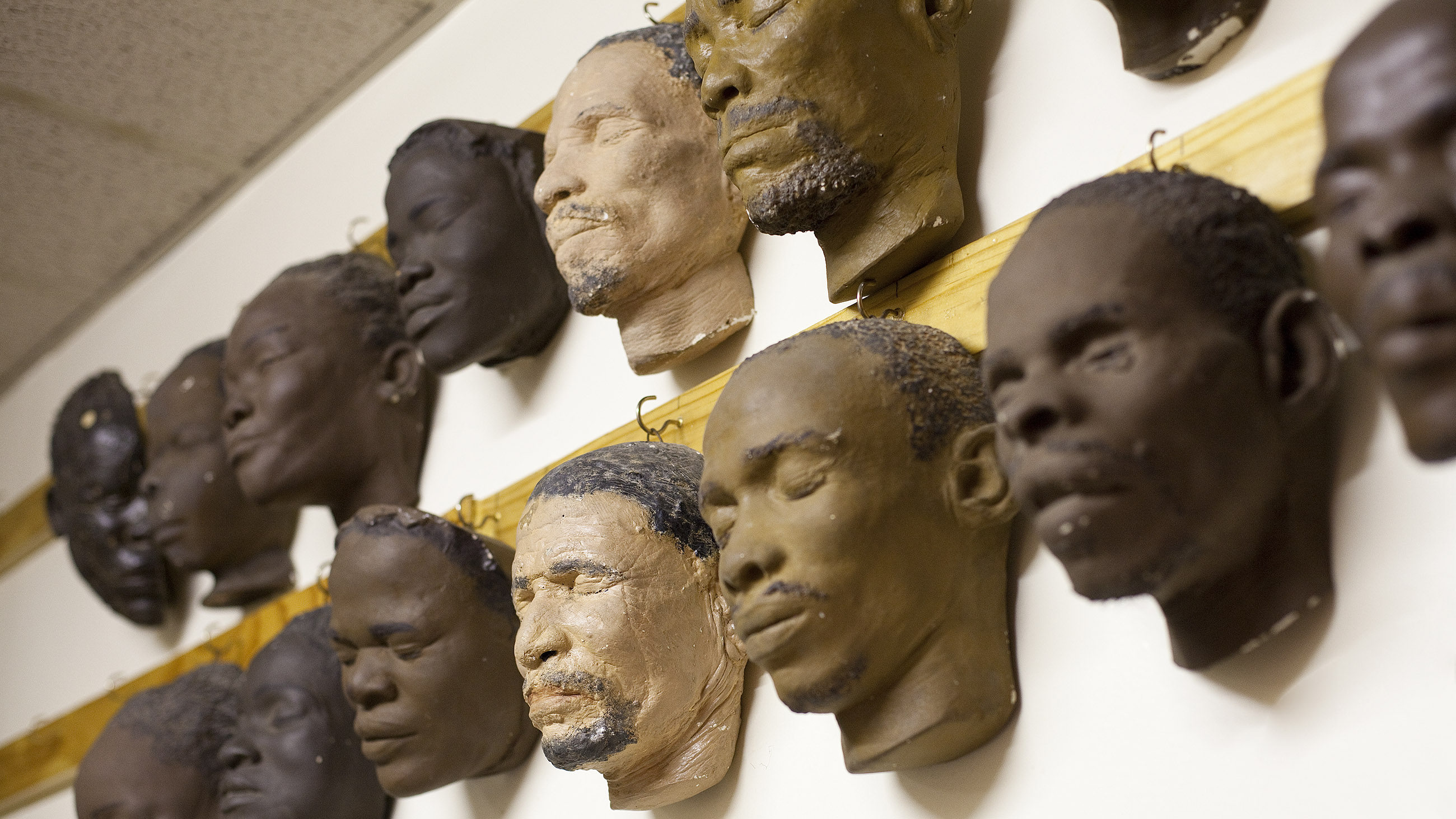 Life masks hang behind the mortuary in  the University of Witwatersrand's health sciences building. Collected to show the differences between tribes and races, researchers now want to use them to help identify bodies.