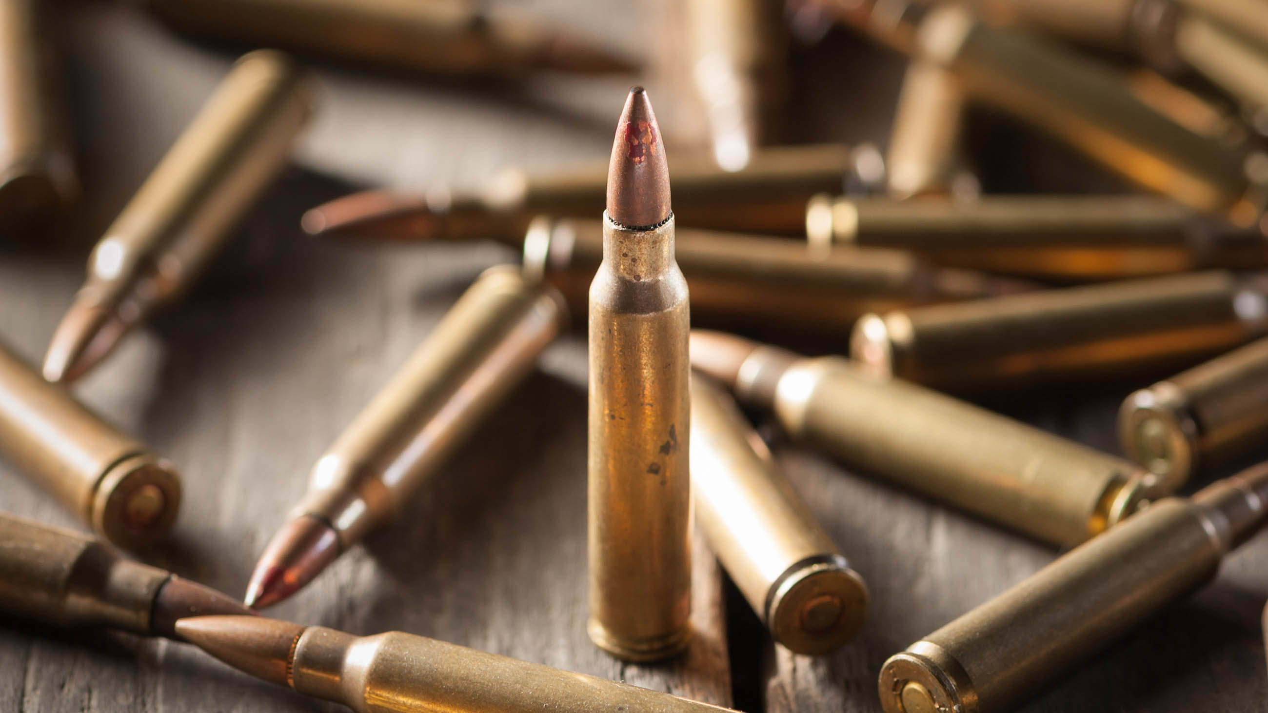 An old metal pistol with a drum on a wooden table.Russian roulette. A  revolver . Stock Photo