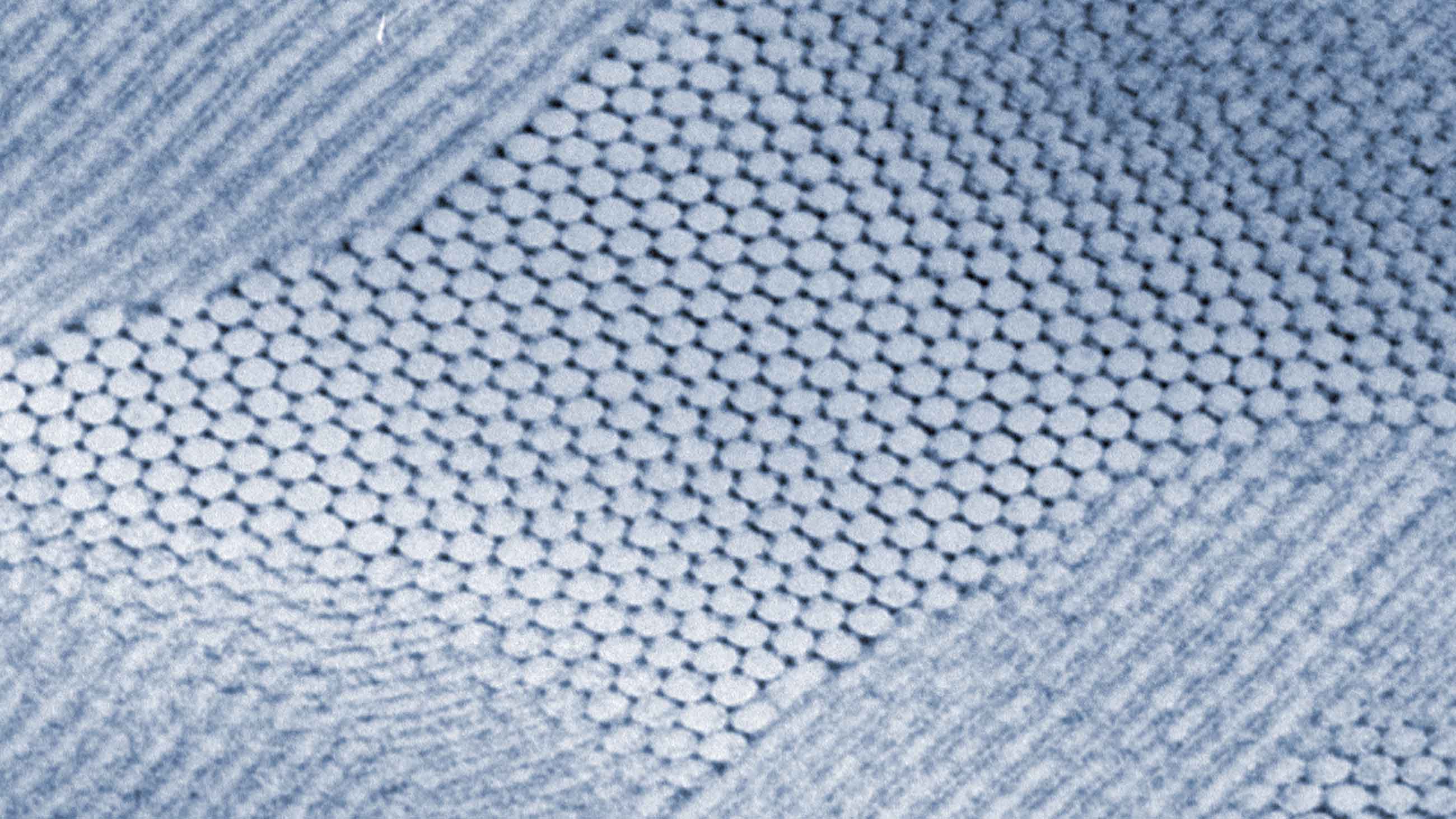 This electron micrograph shows a self-assembled composite in which nanoparticles of lead sulfide have arranged themselves in a hexagonal grid.