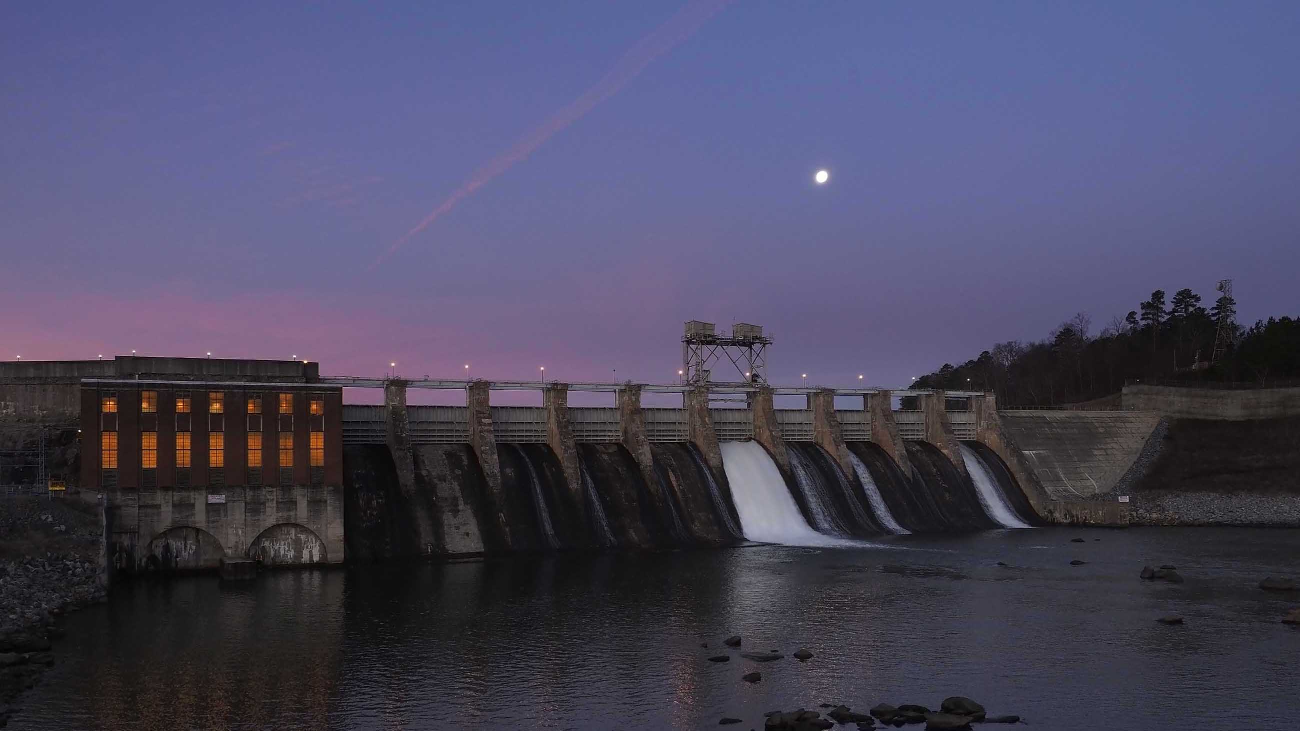 The moon hangs over Lake Hickory as water flows through the gates of the Oxford Hydro Station dam in Conover, North Carolina. The town's textile industry fled to foreign shores long ago, but a high-tech fabric industry is ascendant.