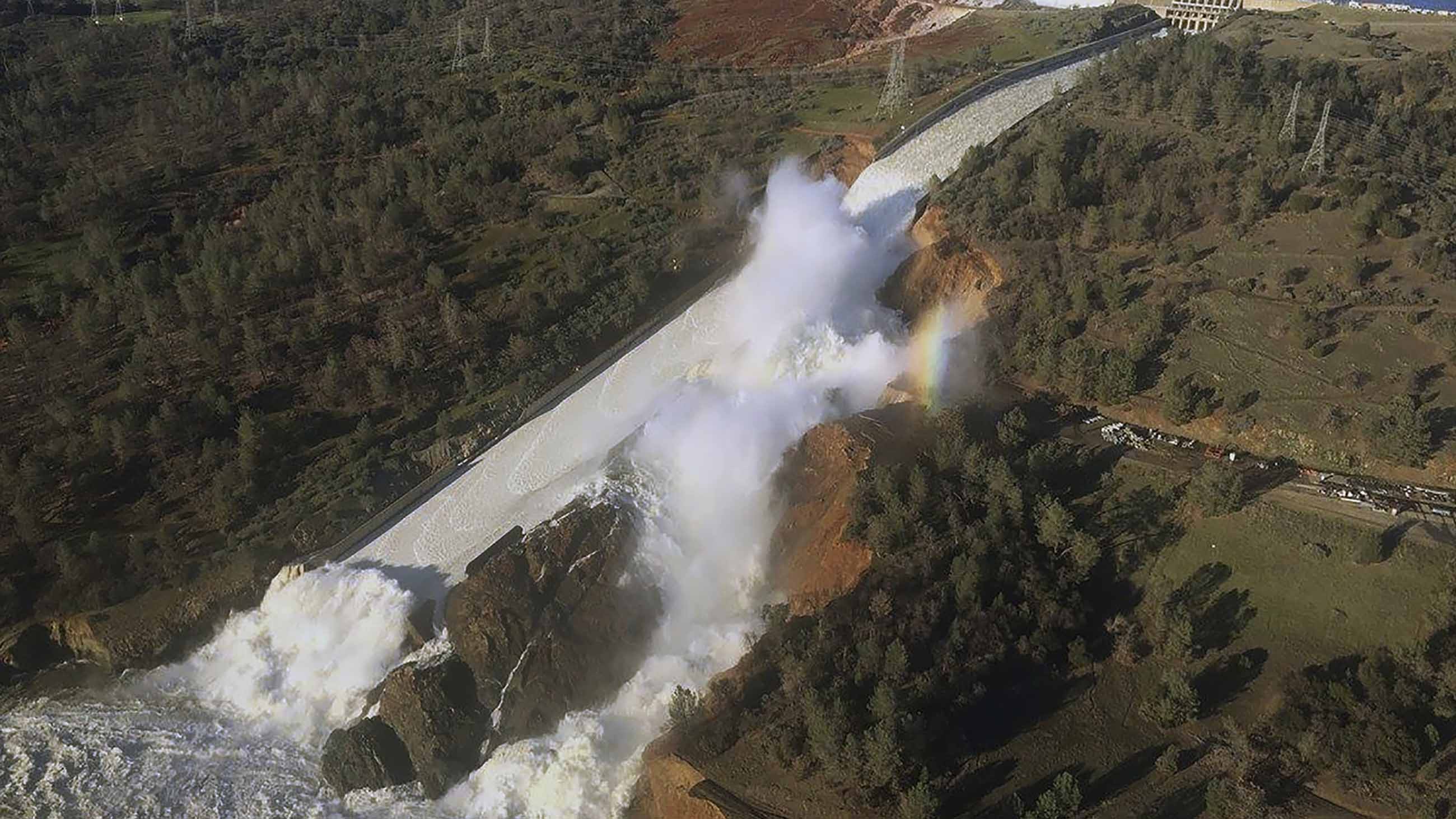 An aerial photo shows the damaged spillway with eroded hillside in Oroville, California.