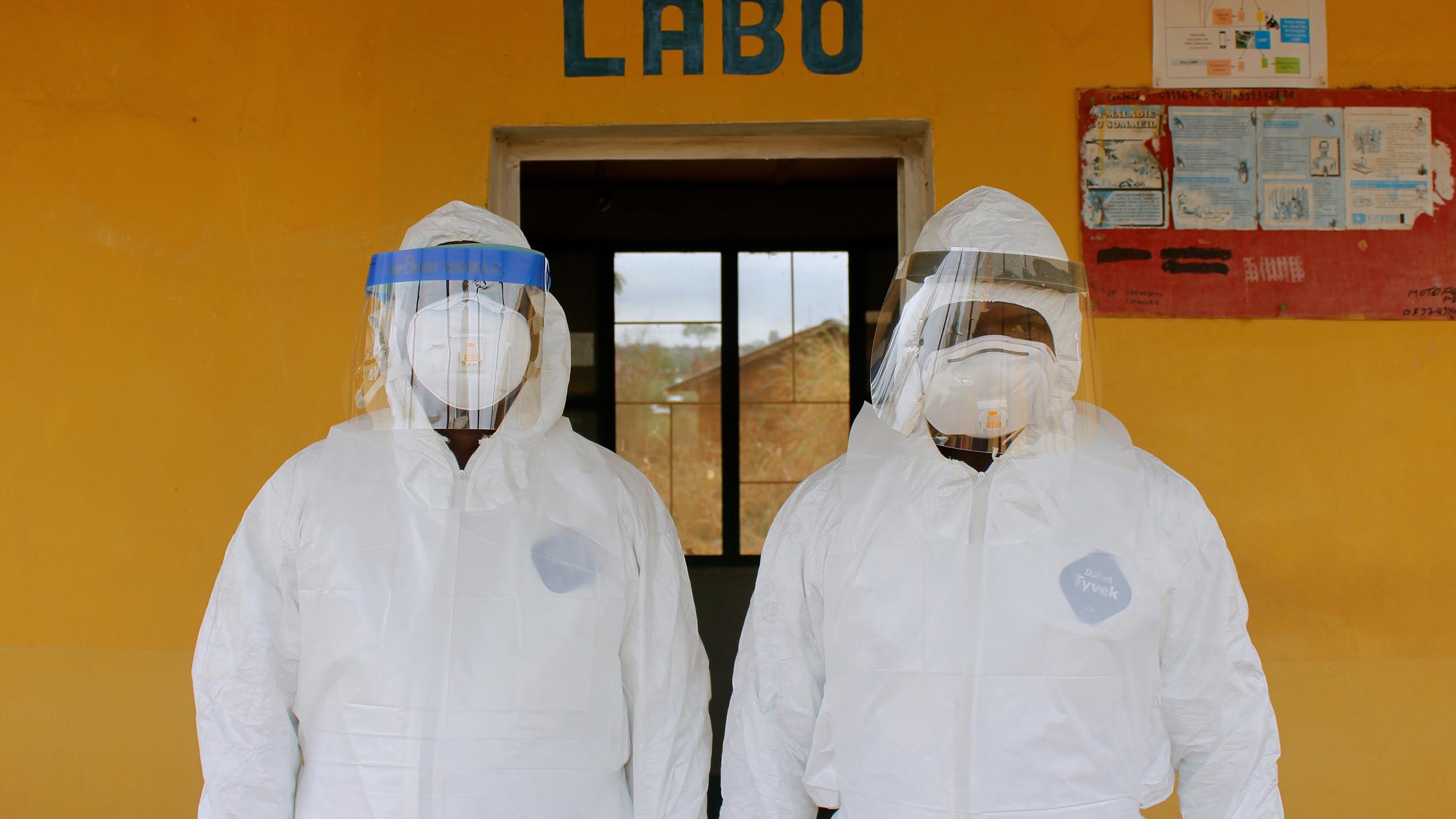 Ipos Lukusa and Guy Midingi are suited up and ready to start sampling bats outside the Kimpese health center.