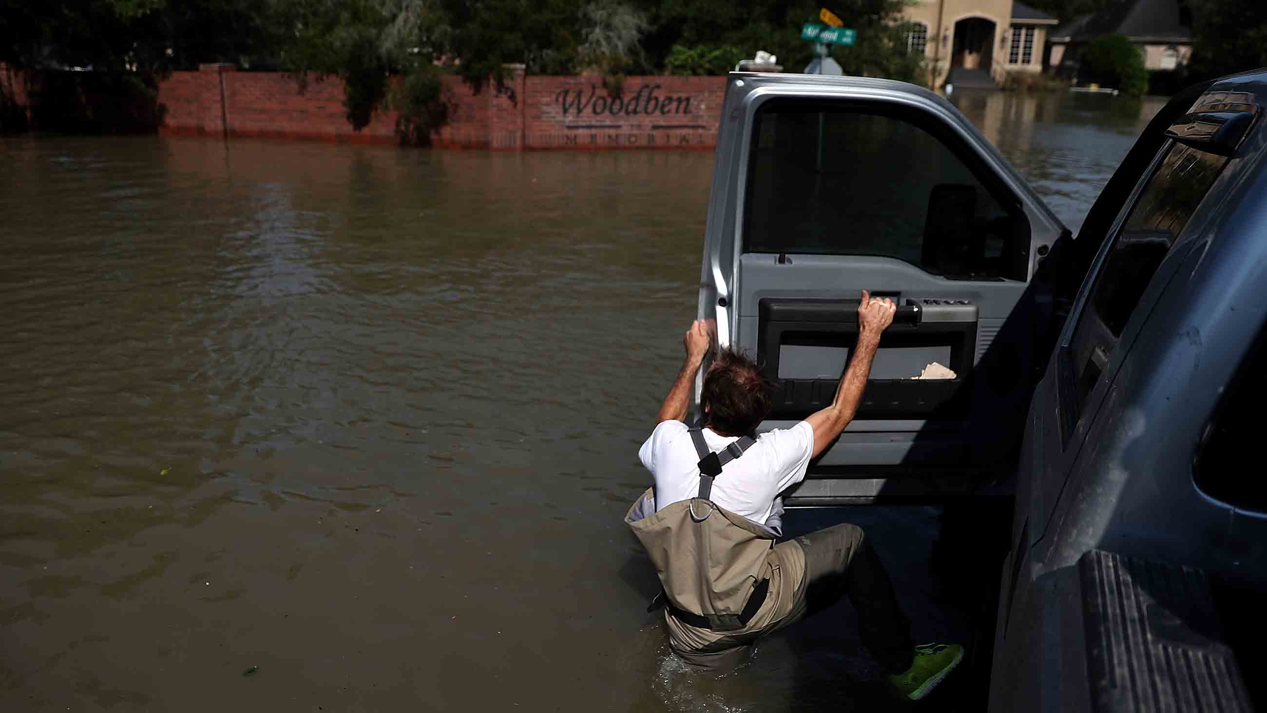 Chris Ginter steps out of his monster truck into deep floodwaters on September 6, 2017 in Houston, Texas.