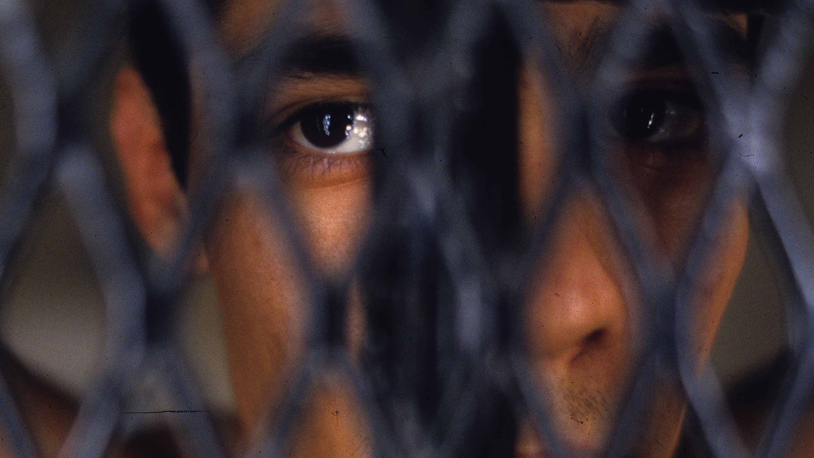 A prisoner looks out of his cell on the Administrative Segregation wing of the Ferguson Unit, January, 1997, outside of Lovelady, Texas. Within the Texas prison system, gang members and others convicted of offenses while in prison are kept seperate from the general population, and confined to their cells all the time, often for years. The use of solitary confinement was a reform measure to separate violent prisoners and career criminals from the general population. However, its over use has had (Photo by Andrew Lichtenstein/Corbis via Getty Images)