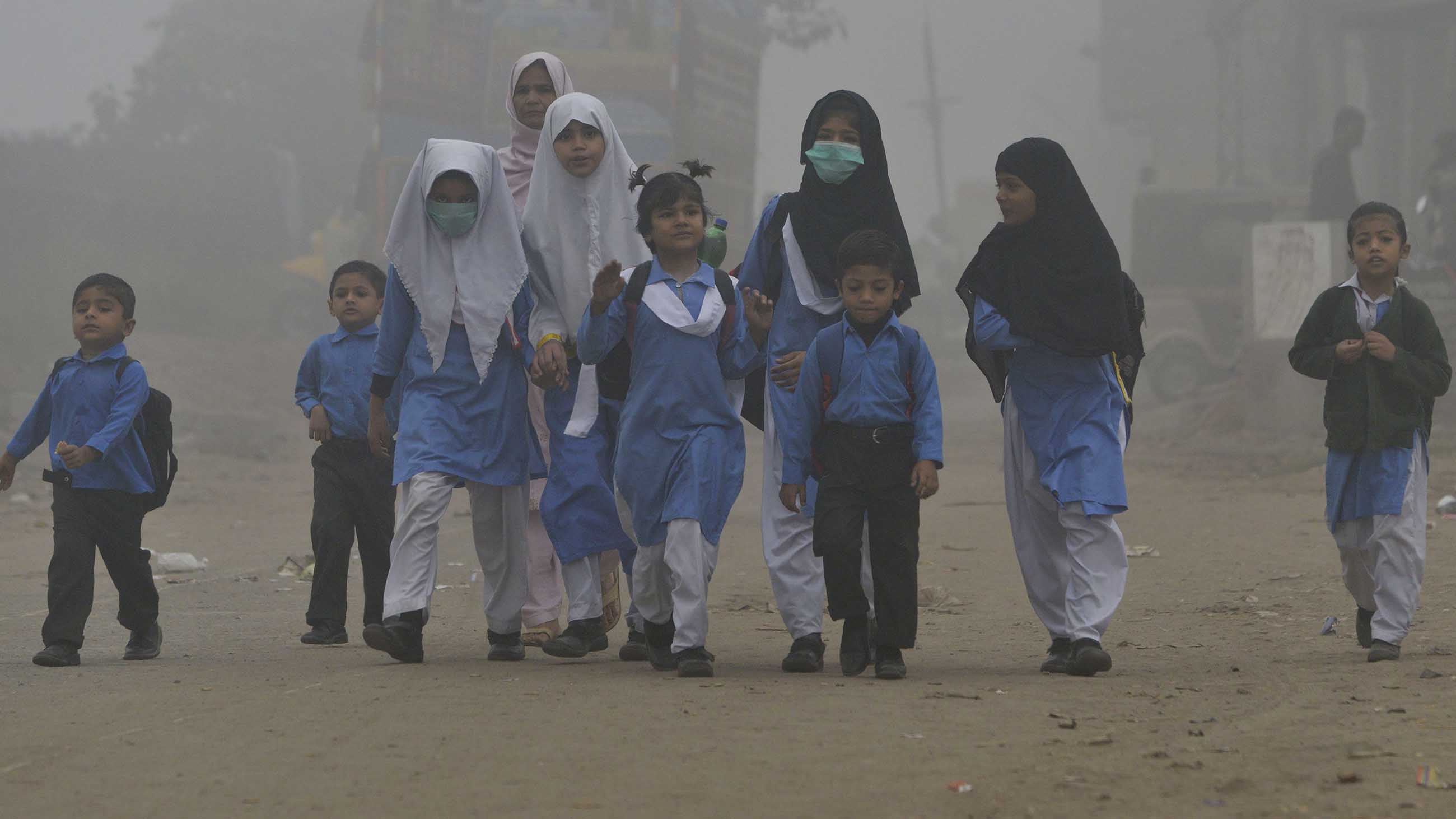Pakistani children walk to school in heavy smog in Lahore in November, 2017.