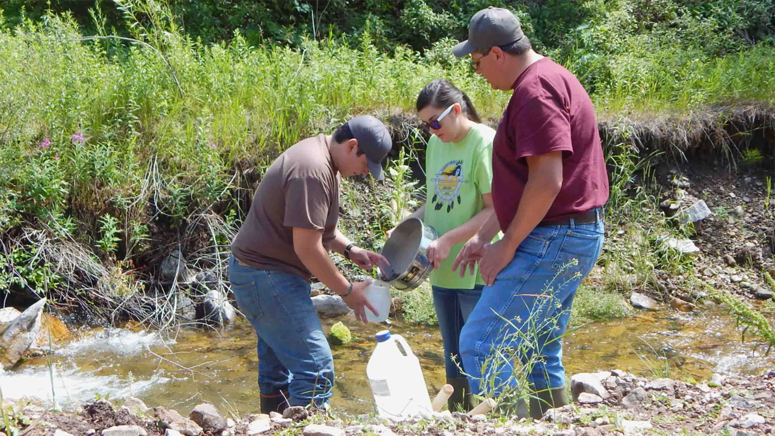 Researchers at Aaniiih Nakoda College gauge the health of a stream that flows into the Fort Belknap Reservation in Montana. Runoff from a gold mine left the stream polluted with heavy metals.