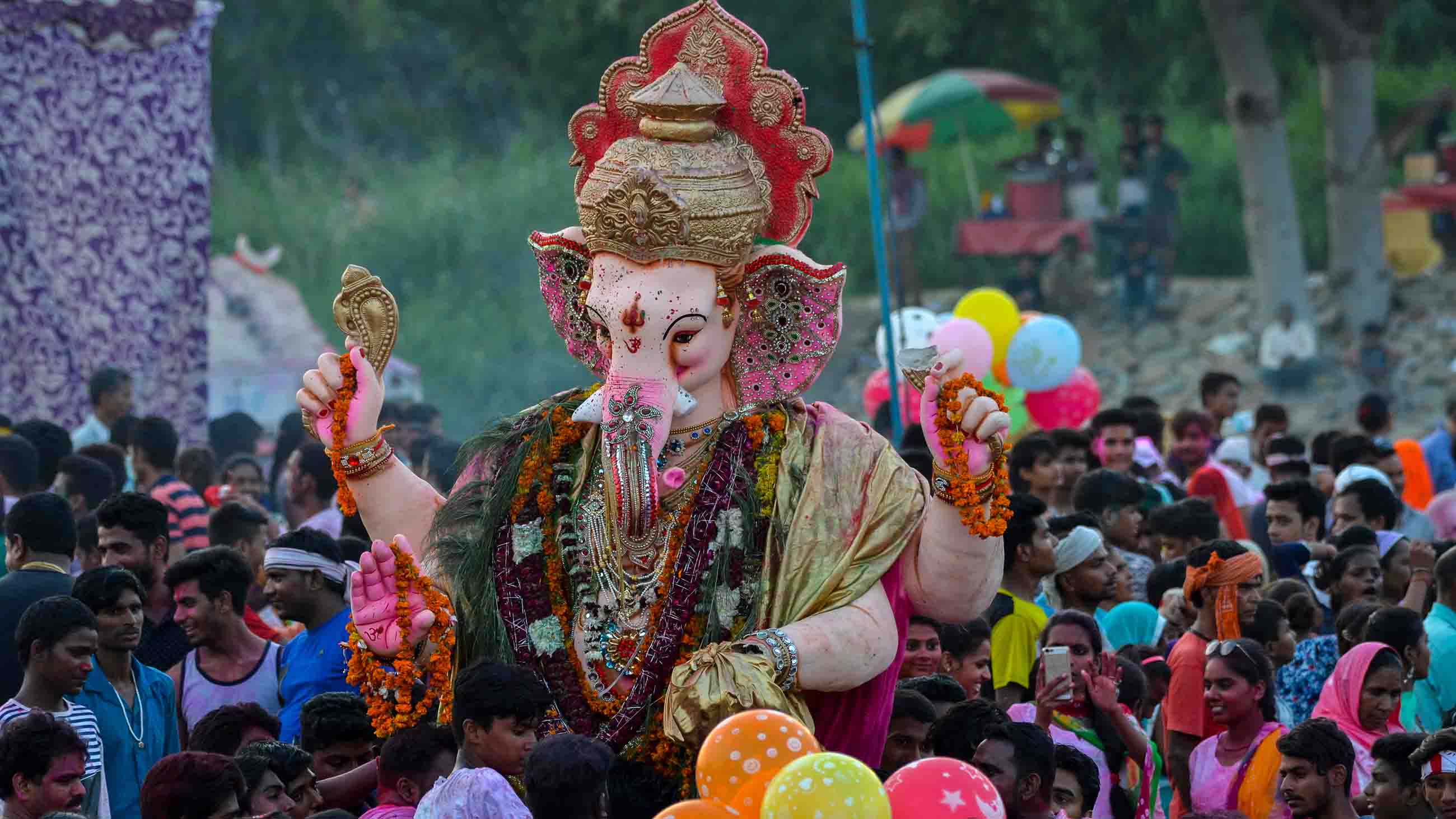 Ganesh Chaturthi Festival, Kalindi Kunj, New Delhi, India- September 5, 2017: People gathered to observe the ceremonial immersion of Lord Ganesh Idols into river Yamuna at Kalindi Kunj, New Delhi, India.