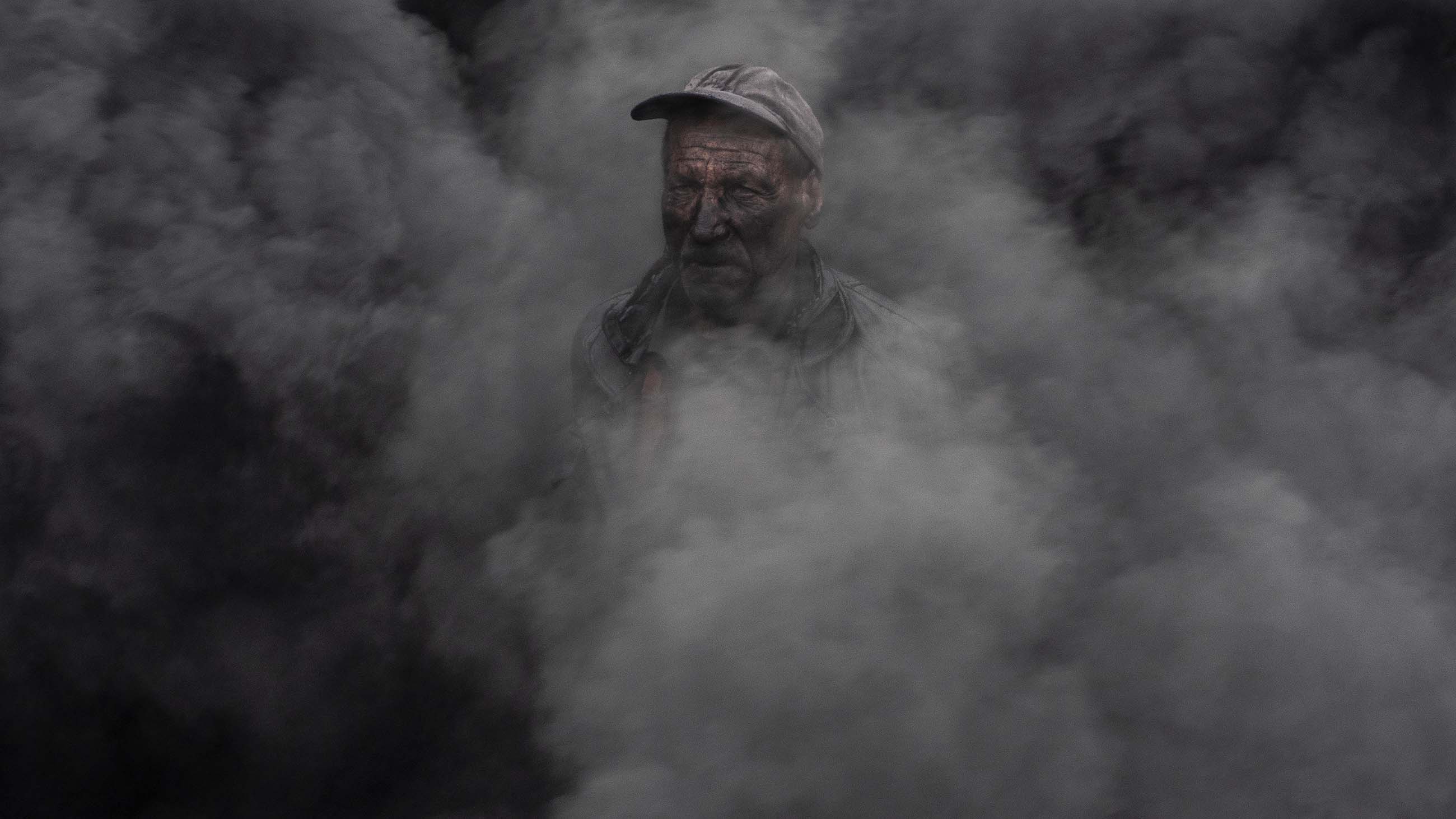 A worker at an outdoor quicklime kiln in the southeastern village of Kosturino, Macedonia. The operation — just one of dozens of prominent sources of air pollution in the country — burns tires for fuel.