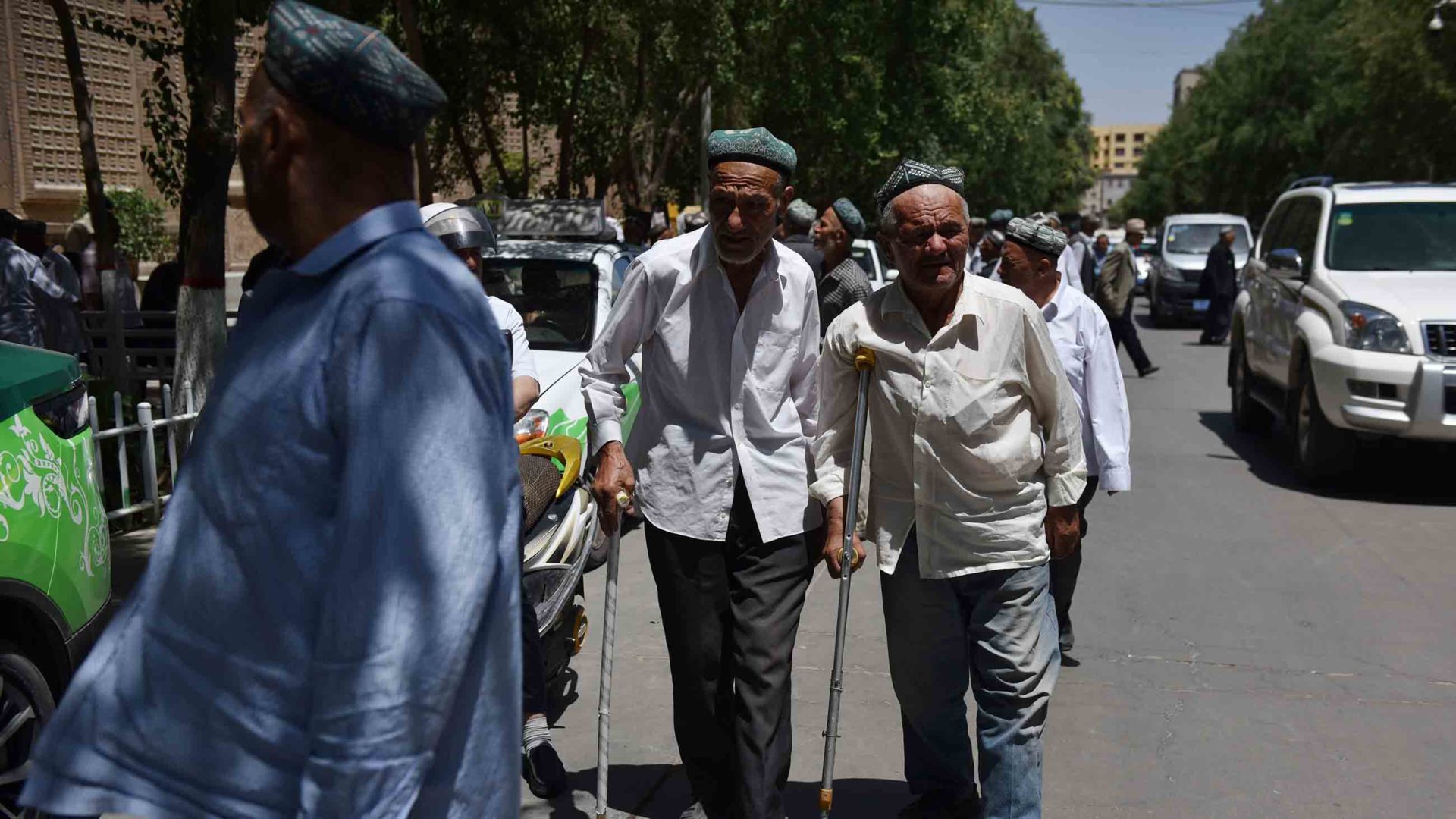 Uighur men leaving a mosque after prayers in Hotan in China's northwest Xinjiang region on May 31, 2019.