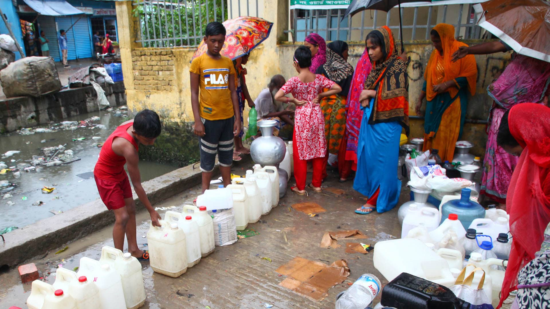 Bangladeshi people collecting drinking water from a water pump in Dhaka in January 2020.
