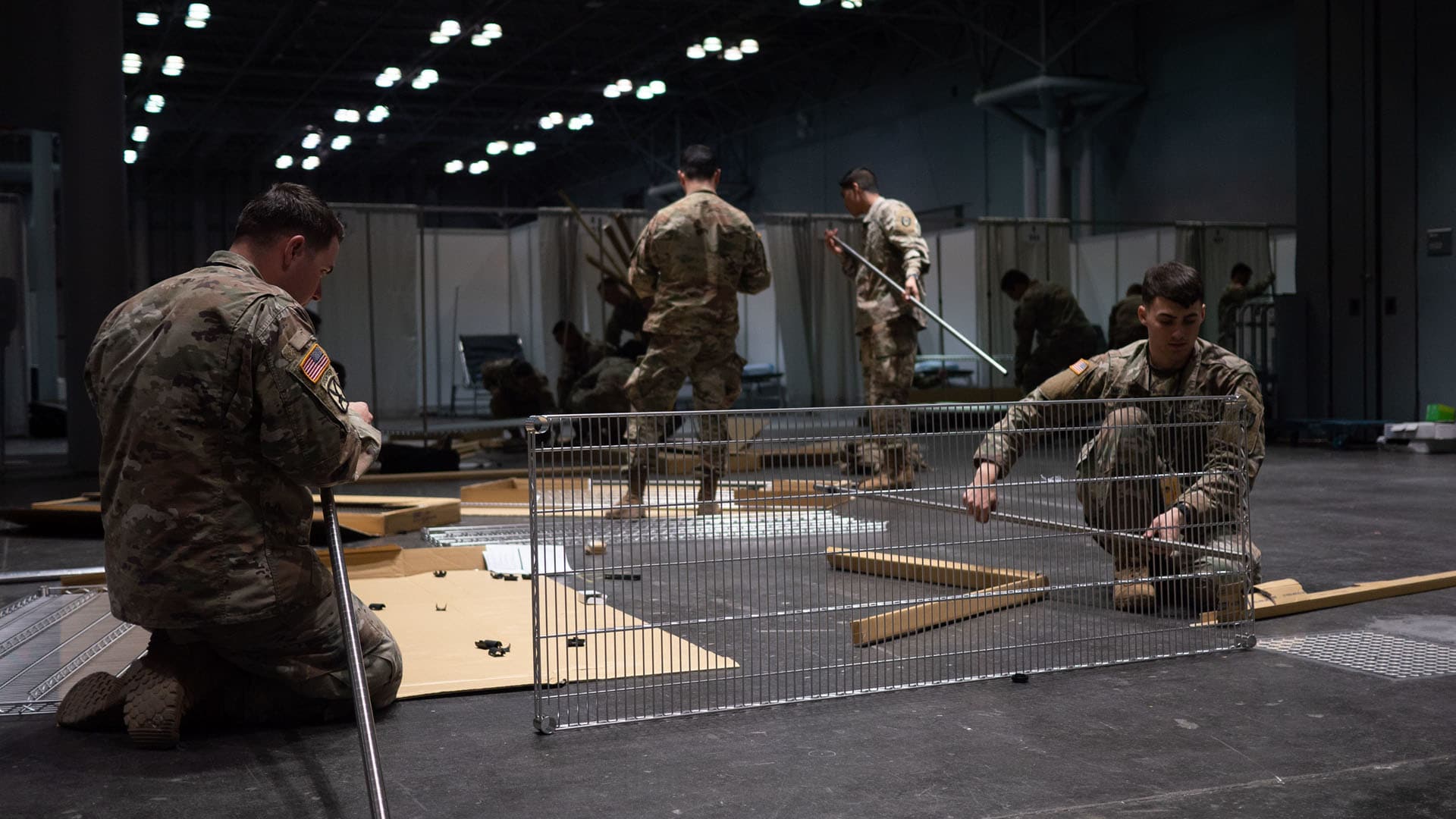 Soldiers assigned to the 531st Hospital Center build shelving at the Jacob K. Javits Convention Center in Manhattan, where a temporary medical station has been constructed to aid efforts combating the Covid-19 pandemic.
