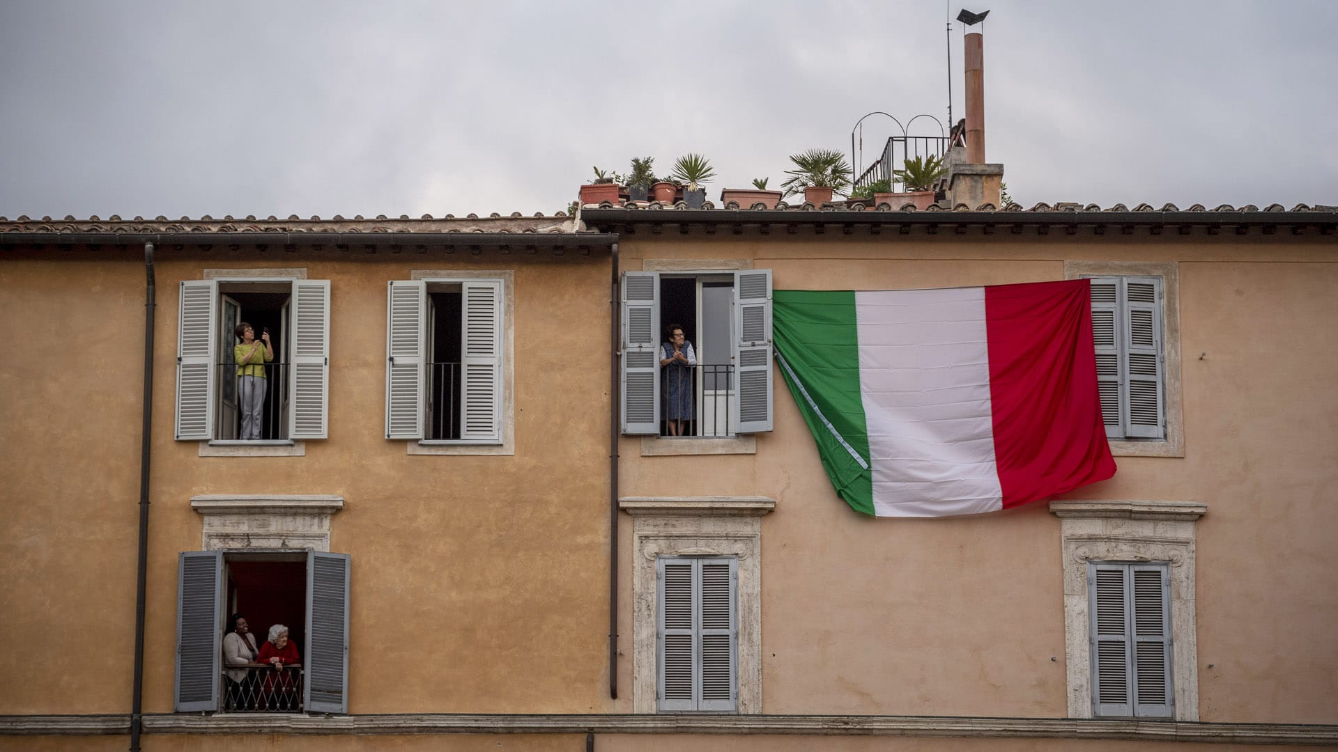 People stand at their window at piazza Navona on April 28, 2020 in Rome, Italy.