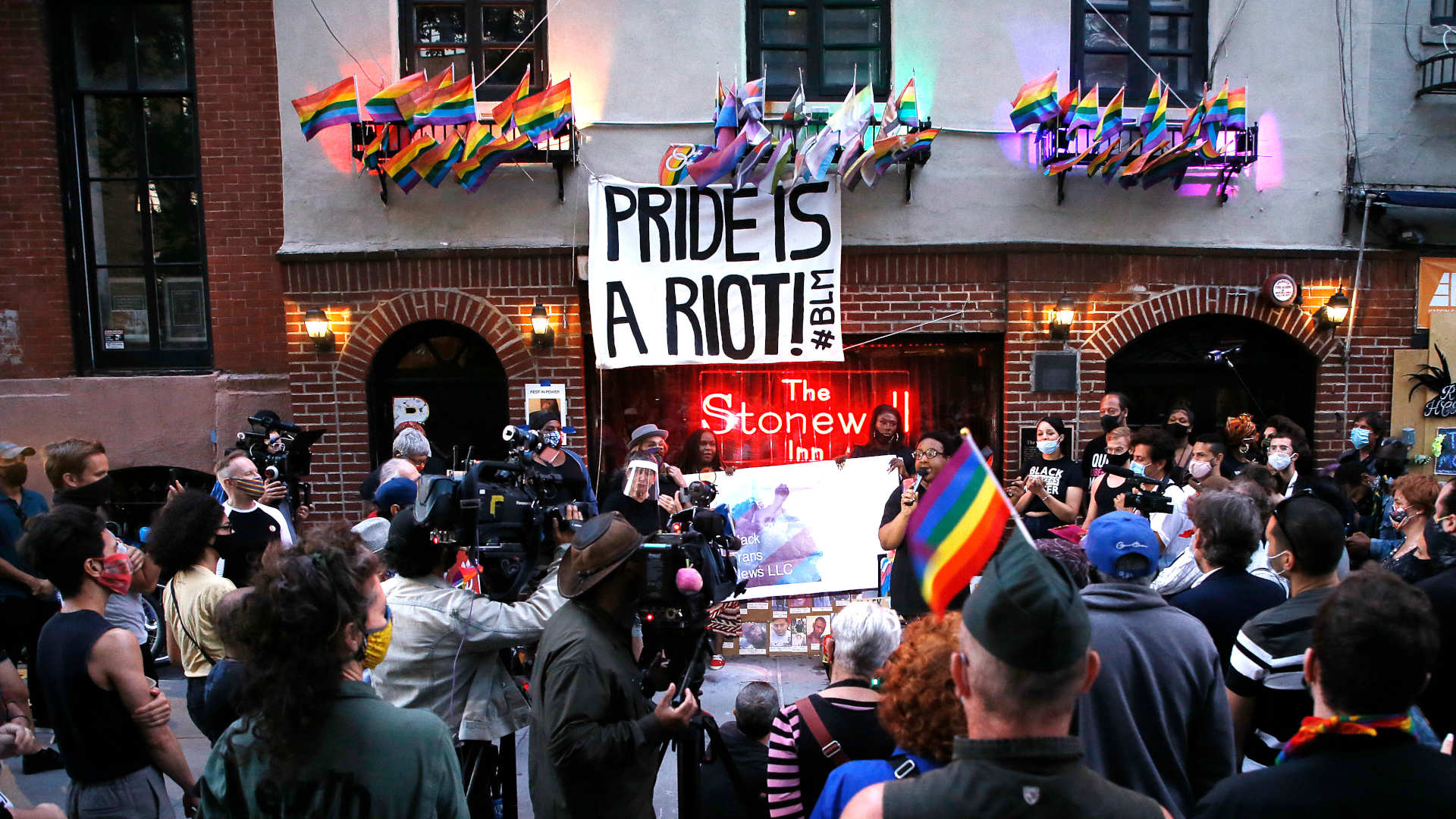 People gather at the historic Stonewall Inn in New York City to celebrate the Supreme Court's recent decision extending the Civil Rights Act of 1964 to LGBT employees, protecting them from workplace discrimination.