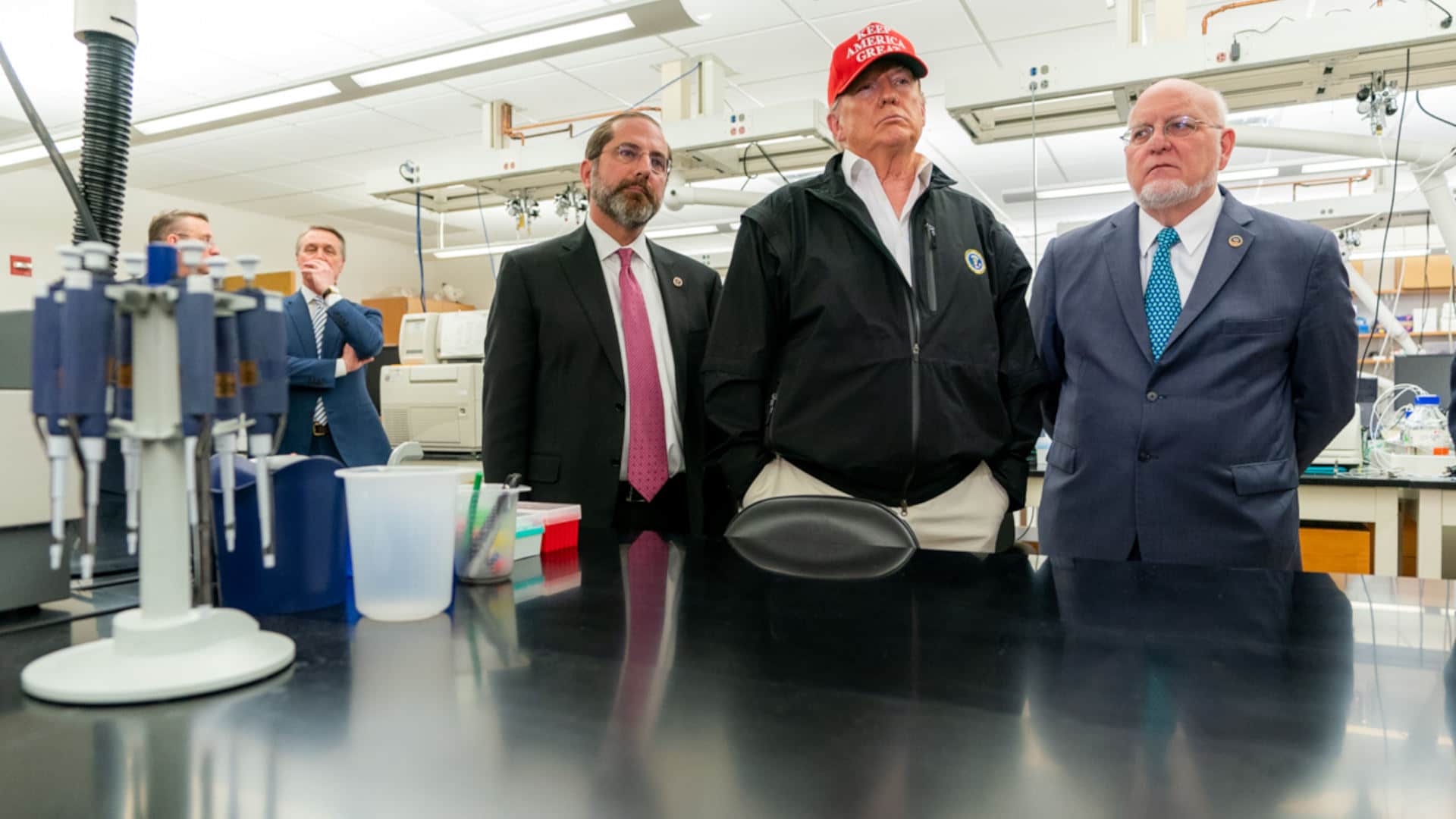 President Trump stands with Robert Redfield, director of the Centers for Disease Control and Prevention, and Secretary of Health and Human Services Alex Azar, at a visit to the CDC's Atlanta headquarters on March 6, 2020.
