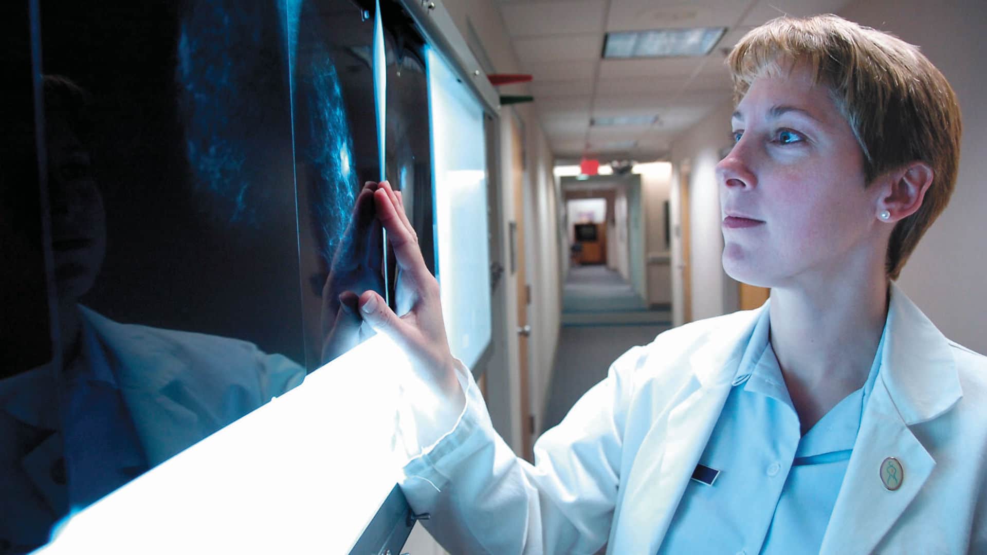 Major (Dr.) Shannon Lehr screens a set of mammogram X-rays taken during a patient's office visit.