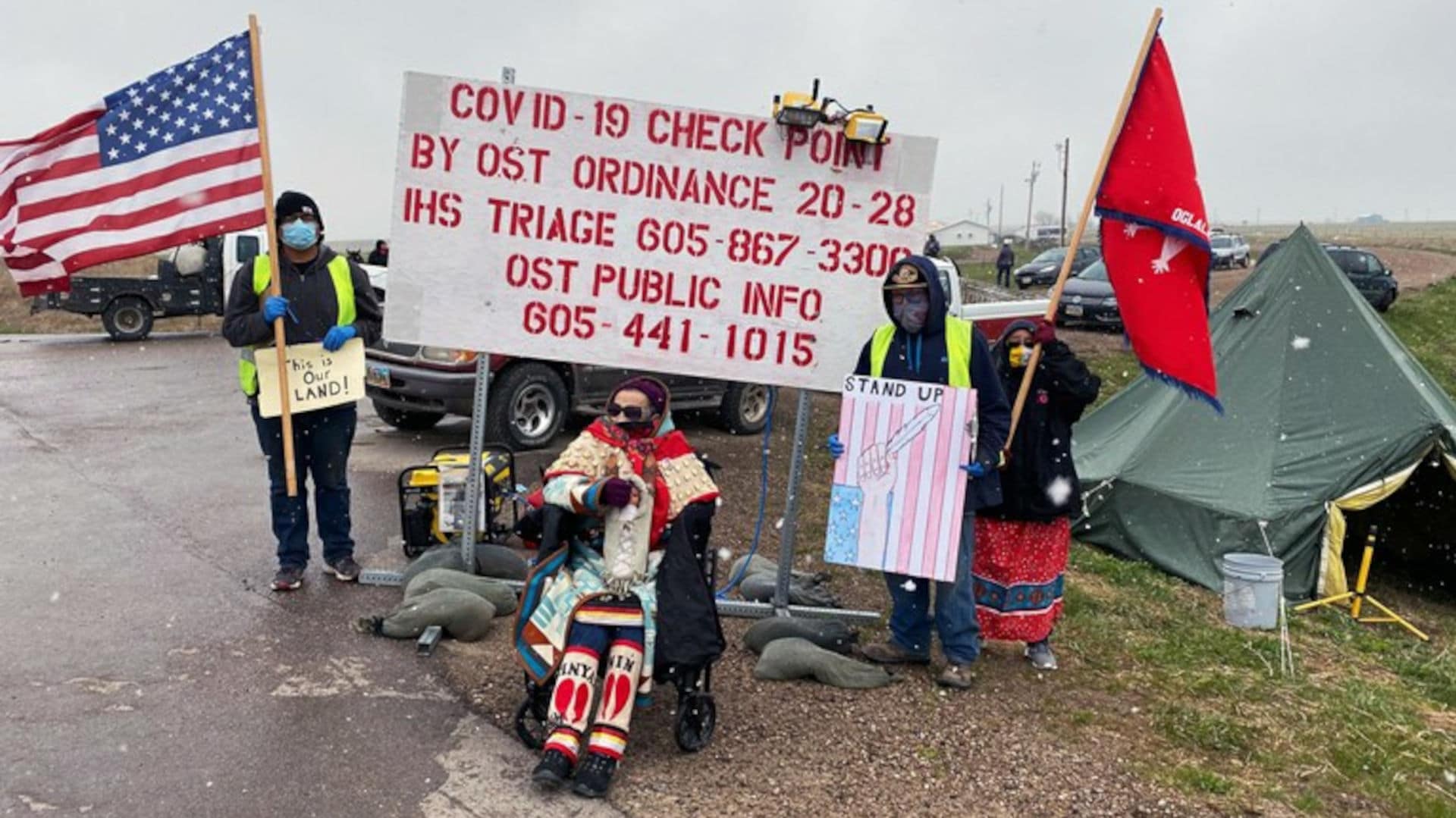 Oglala Lakota Tribal Member Emma Waters, 89, sits between Pine Ridge Reservation border patrol workers and her daughter in support of Covid-19 checkpoints operated by the Cheyenne River Sioux and Oglala Sioux tribes.