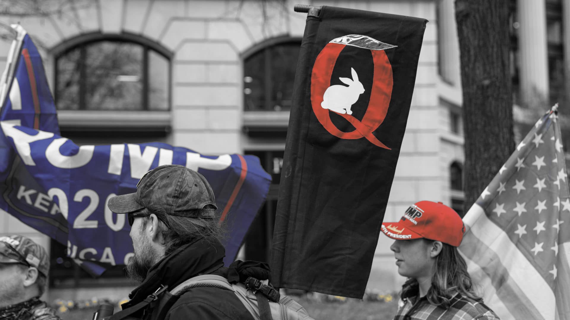 Trump supporters hold a QAnon sign at a rally on Jan 5, 2021. The next day, many supporters stormed the Capitol, temporarily stopping Congress from certifying the 2020 election.