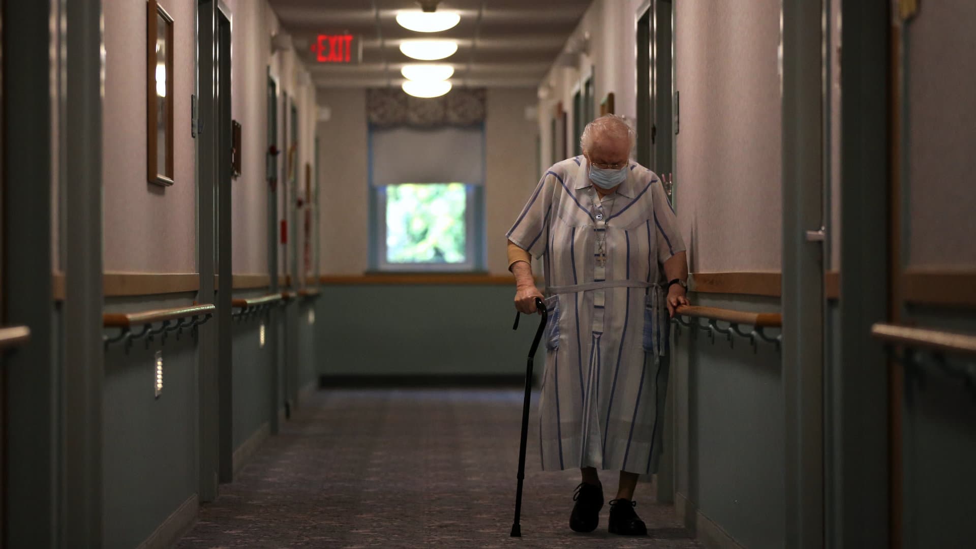 Louisa Perreault, who had a month long battle with Covid-19 during an outbreak in April, passes down the hall at St. Chretienne Retirement Residence in Marlborough, MA.