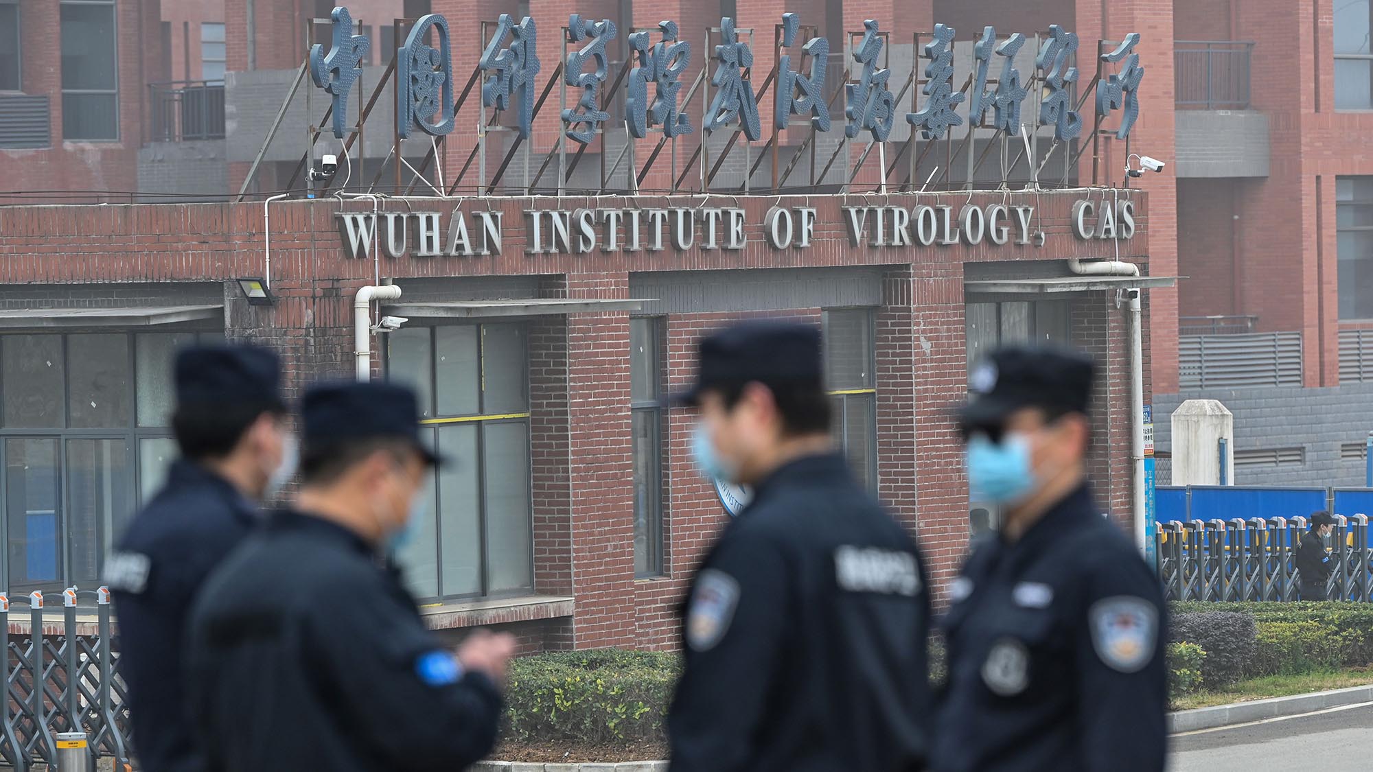 Security personnel stand guard outside the Wuhan Institute of Virology in Wuhan in February, as members of the World Health Organization (WHO) team investigating the origins of the Covid-19 coronavirus pay a visit.