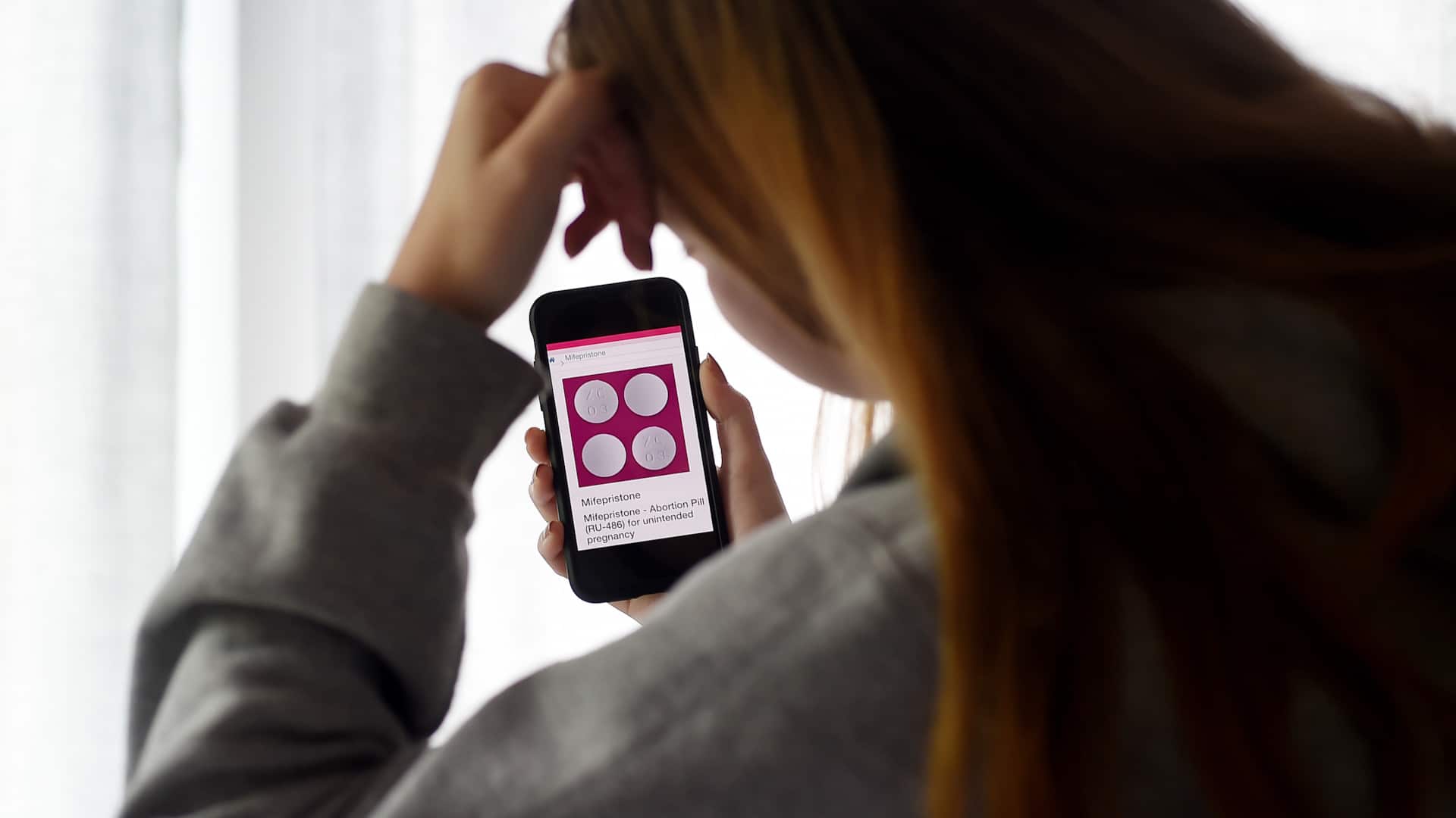Medication abortion involves taking two medications, mifepristone and misoprostol, displayed here on a smartphone. Until last July, the FDA required these medications to be dispensed in a clinic, despite evidence for their safety at home.