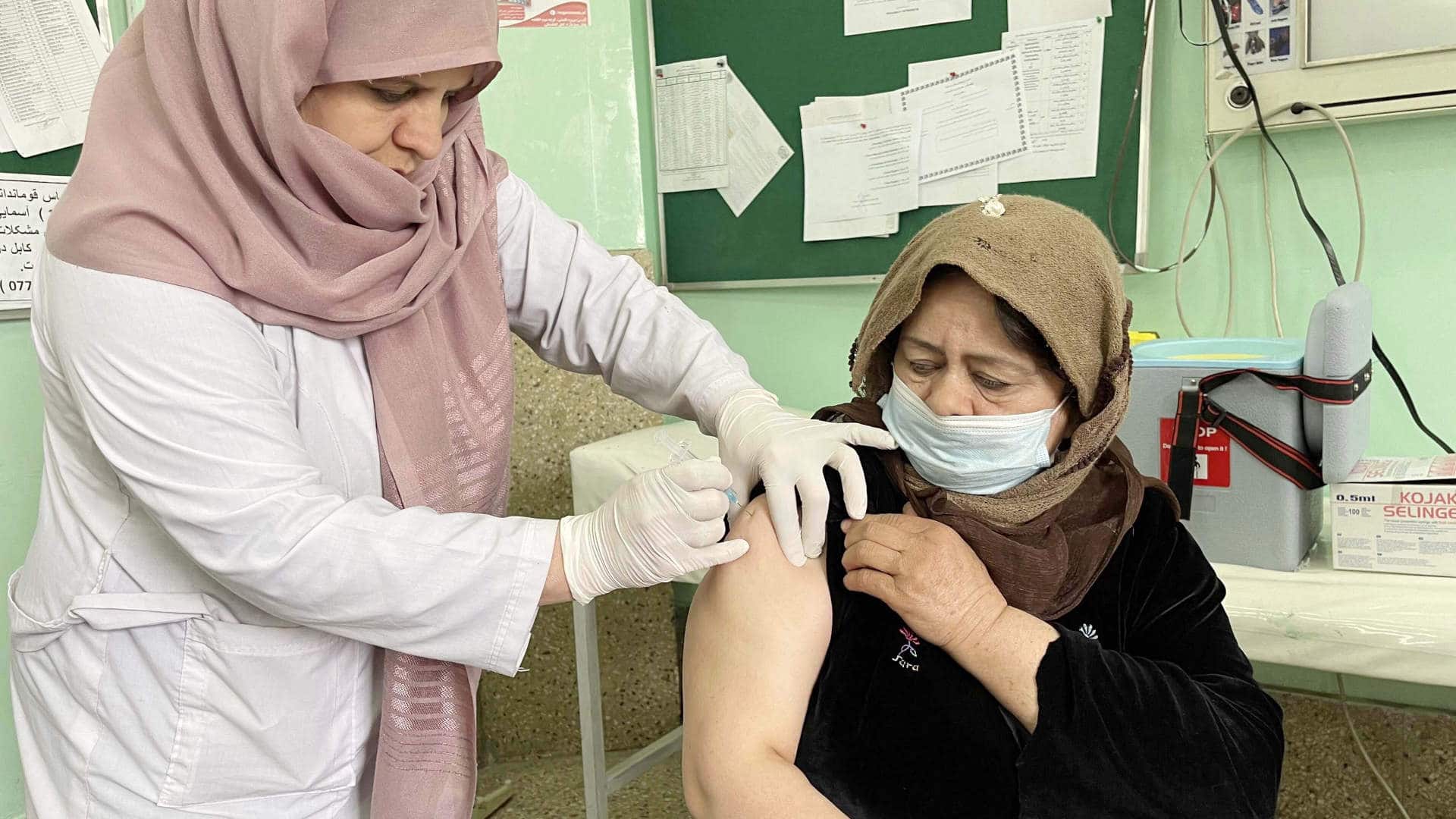 An Afghan health worker receives a dose of the Indian version of the AstraZeneca coronavirus vaccine at Wazir Akbar Khan Hospital in Kabul, Afghanistan on February 27, 2021.