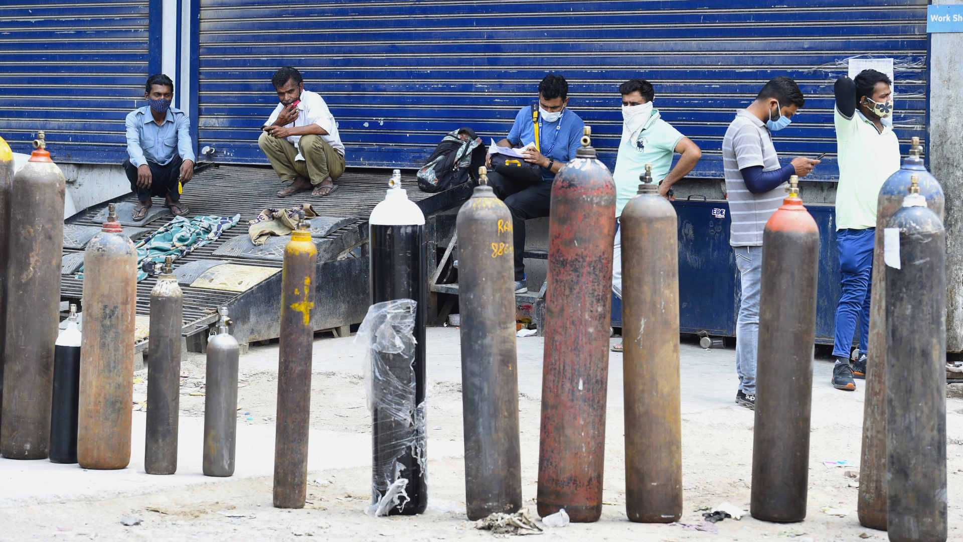 People waiting for oxygen cylinders in the Mayapuri Industrial area of New Delhi, India on May 8, 2021.