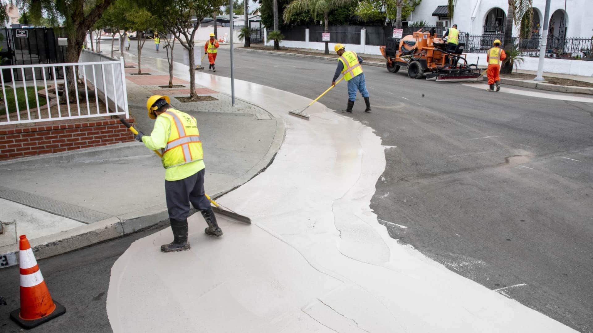 City workers apply a cooling paint on roads in Pacoima, Los Angeles.