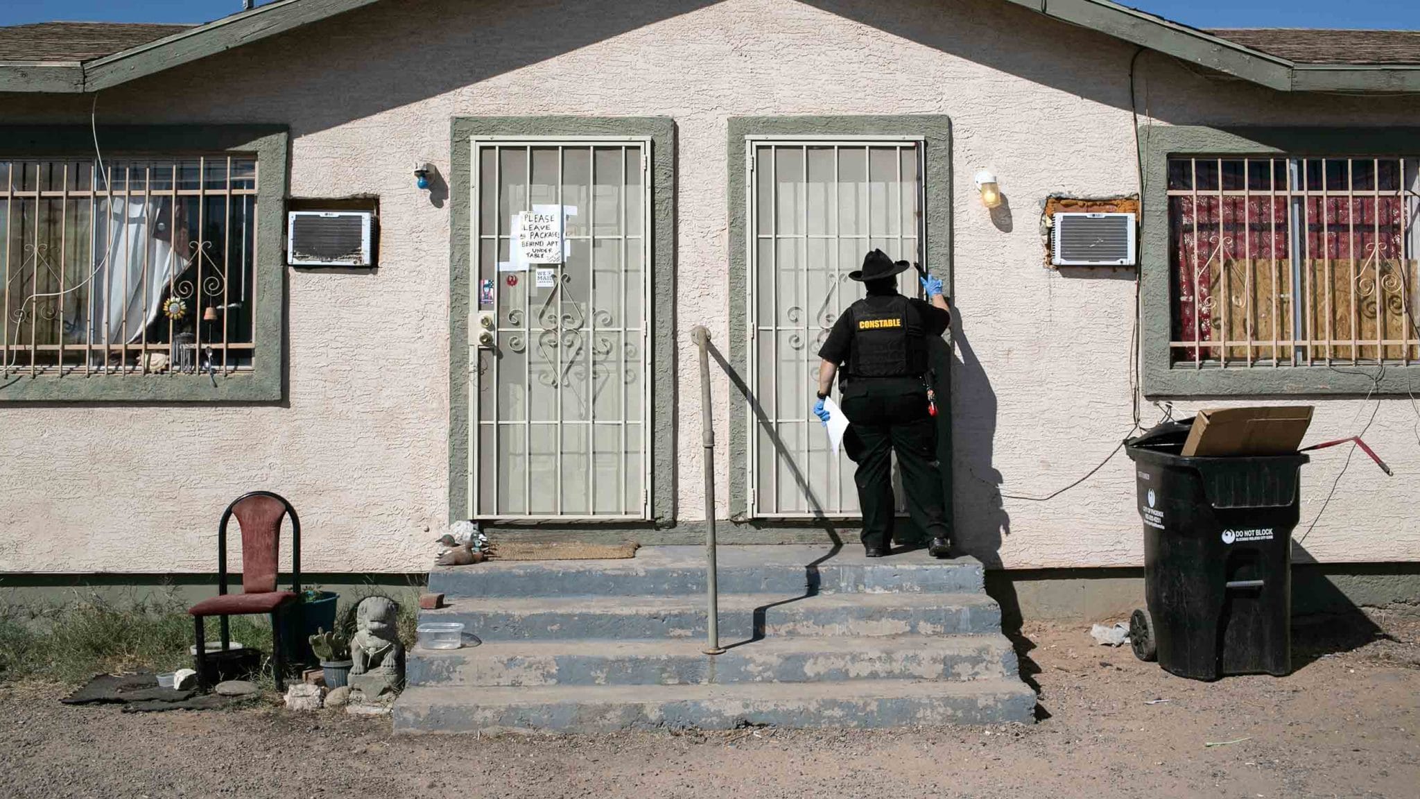 Maricopa County constable Darlene Martinez knocks on a door before posting an eviction order on October 1, 2020 in Phoenix, Arizona.