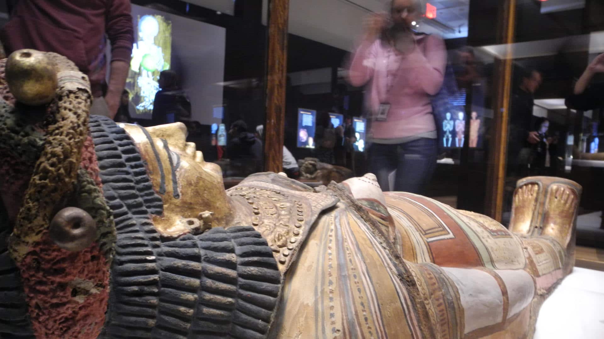 A visitor photographs a casket lid from ancient Egypt at the exhibition "Mummies" in the American Museum of Natural History in New York, March 2017.