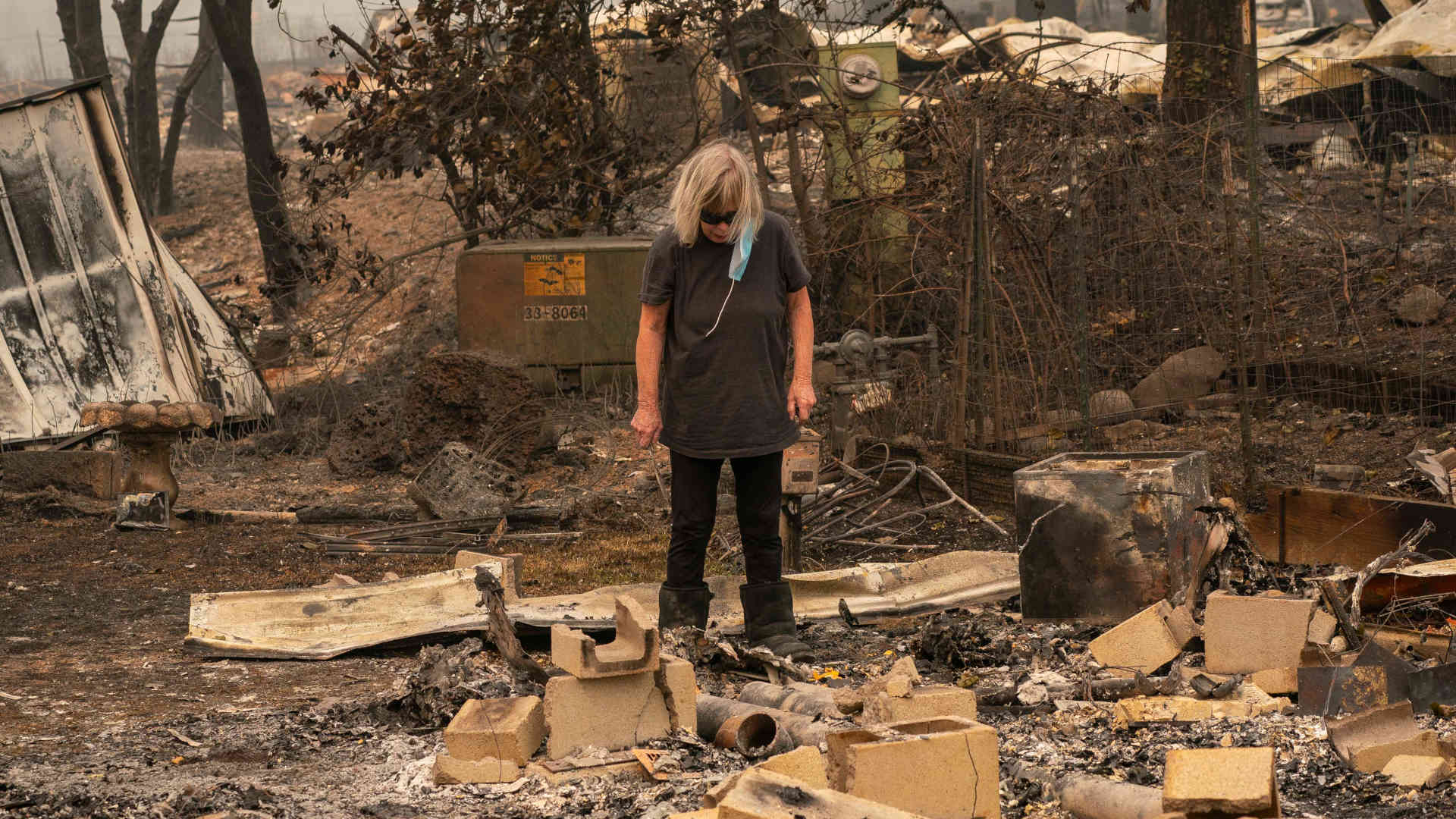 Sandy Casso stands in the rubble of her burnt home in a mobile home park on September 11, 2020 in Ashland, Oregon.