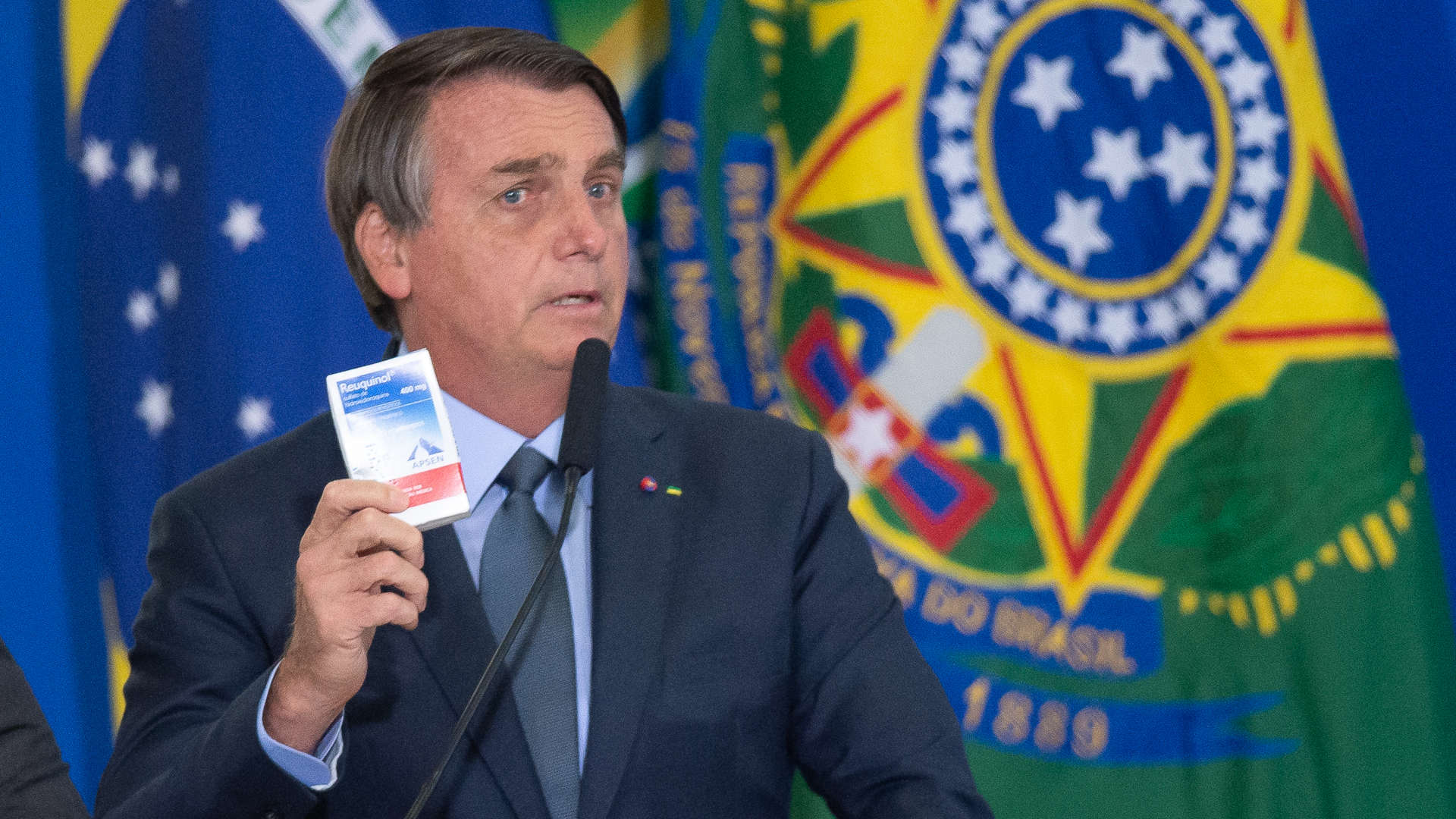 President of Brazil Jair Bolsonaro holds up a box of hydroxychloroquine during a ceremony in which Eduardo Pazuello took office as Minister of Health on Sept. 16, 2020.