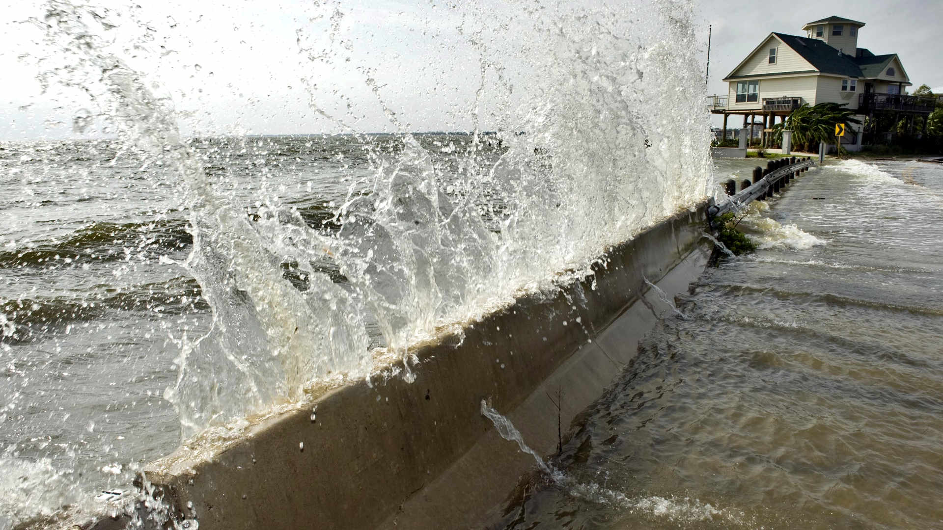Water from Galveston Bay crashes over a barrier September 12, 2008 in Seabrook, Texas. When Hurricane Ike hit the next day, it caused massive flooding and wiped out some 3,600 homes.