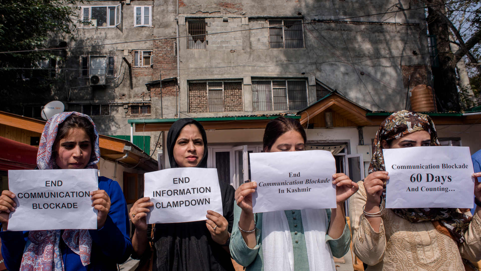 Kashmiri women journalists hold placards as they protest against the continued communication blockade by the Indian authorities after the revocation of special status of Kashmir on Oct. 3 , 2019 in Srinagar.