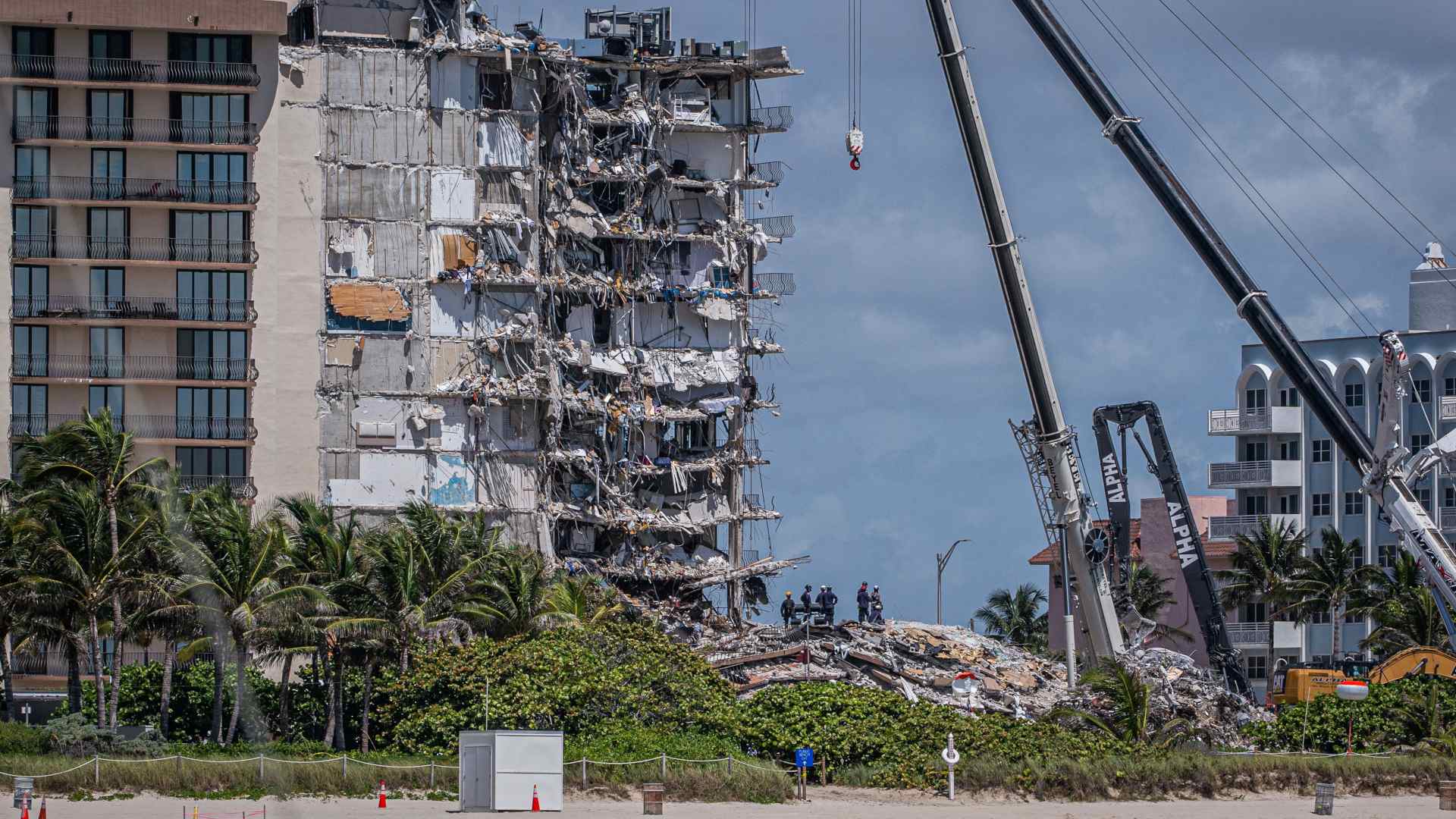 At the partially collapsed 12-story Champlain Towers South condo, members of a search and rescue team look for possible survivors on June 27, 2021.