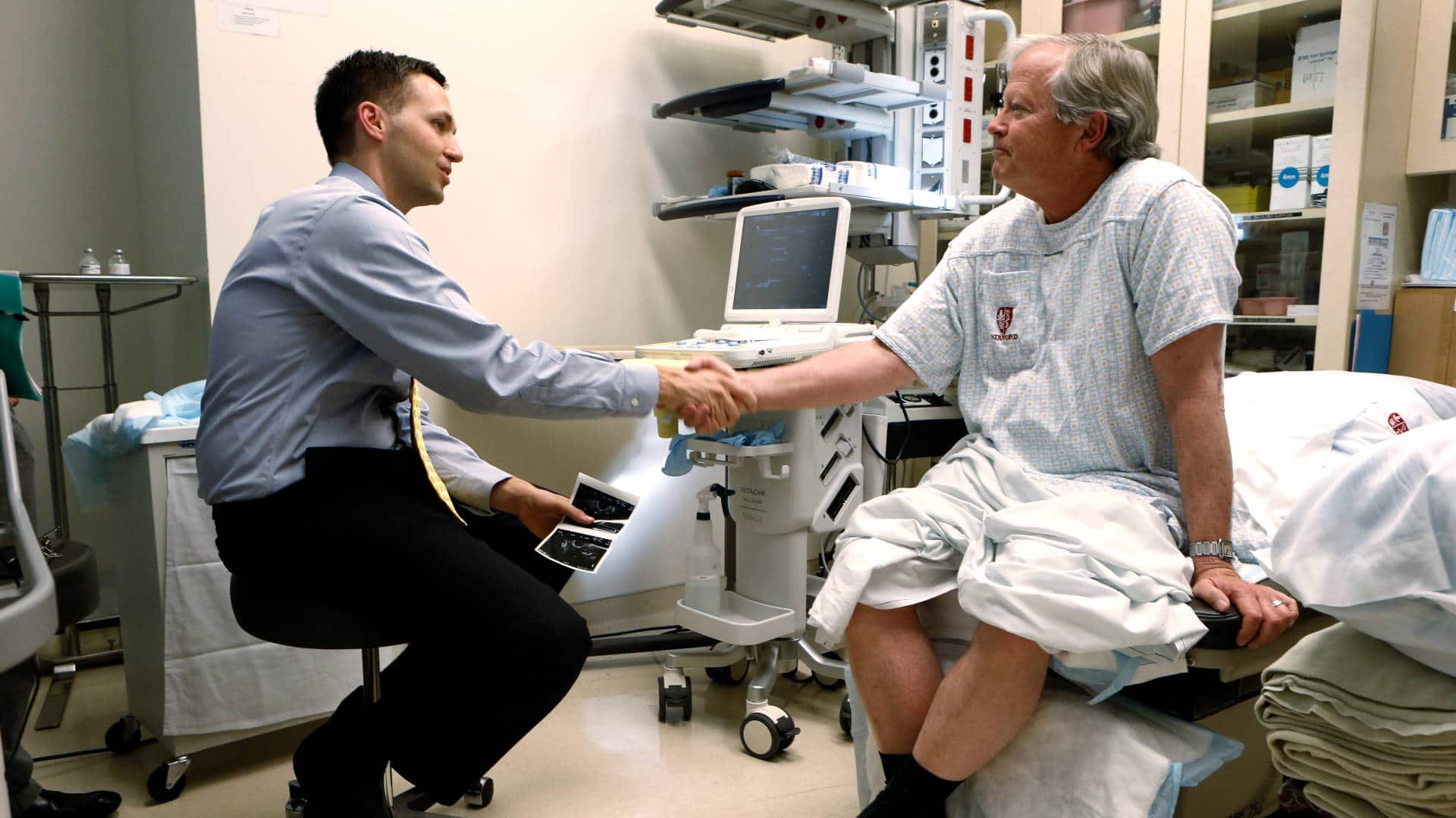 A patient thanks his oncologist after a prostate biopsy procedure.