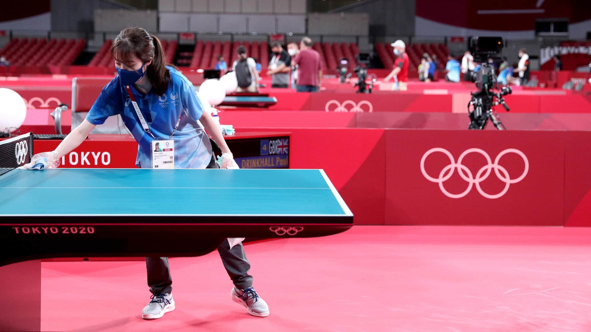 A worker disinfects a table tennis court ahead of the Tokyo 2020 Olympic Games on July 21, 2021.