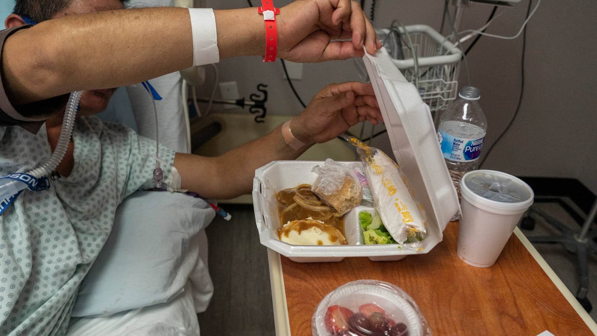 A patient opens their lunch box in the Covid-19 intensive care unit on Christmas Eve at the United Memorial Medical Center in Houston, Texas.