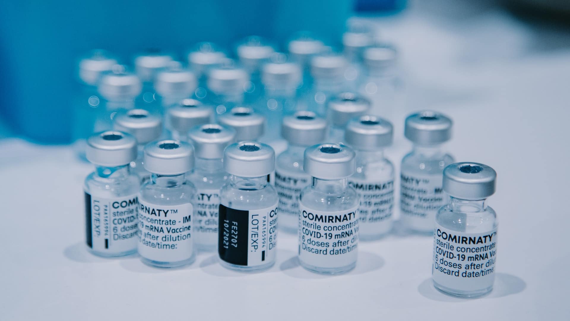 A collection of vials of the Pfizer/BioNTech Covid-19 vaccine, with the brand name Comirnaty visible.
