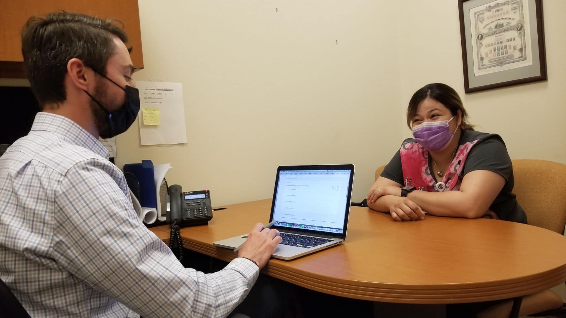 Attorney Marc Scanlon  meets with client Kimberly Ledezma at Salud Family Health Centers’ clinic in Commerce City. He helped her prepare for a U.S. citizenship test.