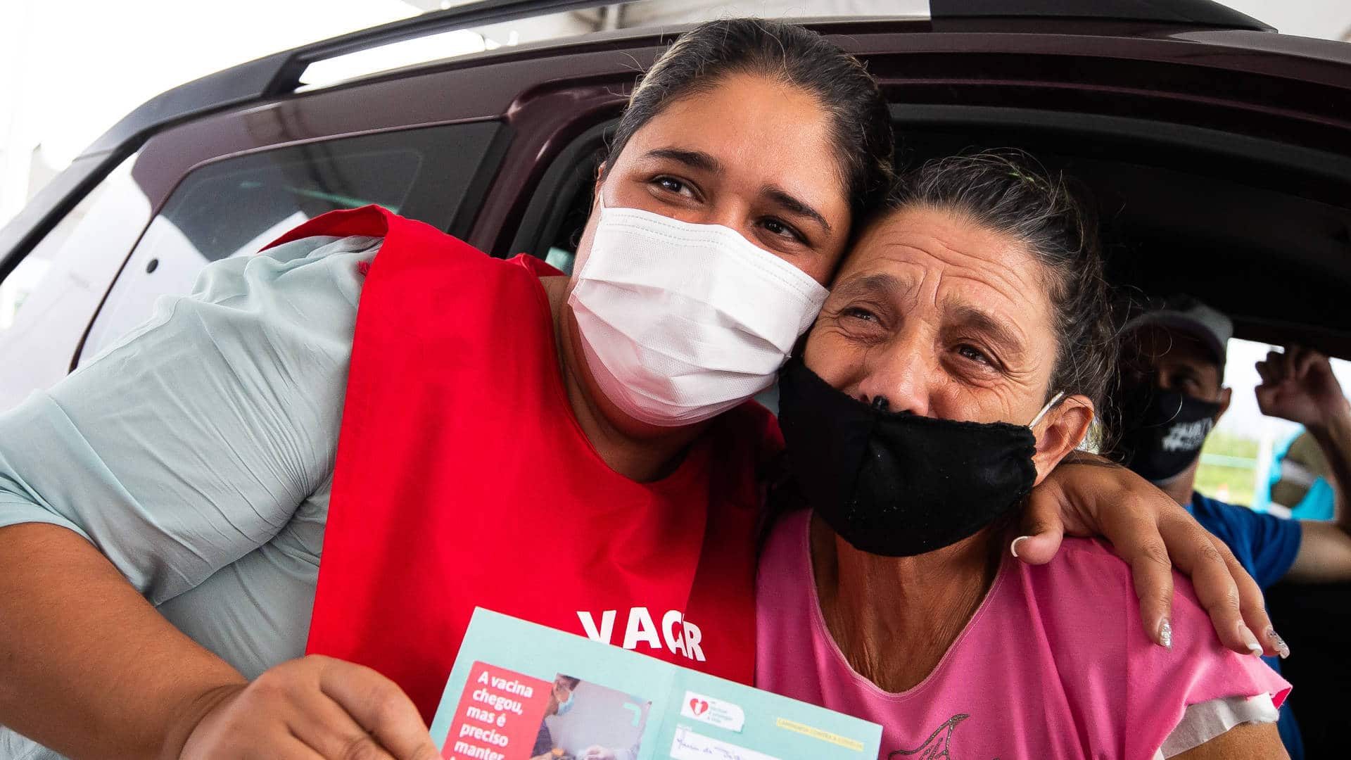 Maria de Fátima Moreira (R) receives a Covid-19 vaccine dose from her daughter, Andreia Moreira Pereira da Costa (L), who is a nurse in Maricá, Brazil, on April 27 2021.
