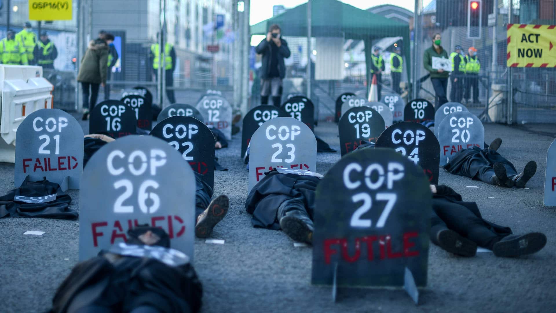Extinction Rebellion protesters perform a die-in protest outside the entrance to the COP26 site on Nov. 13, 2021.