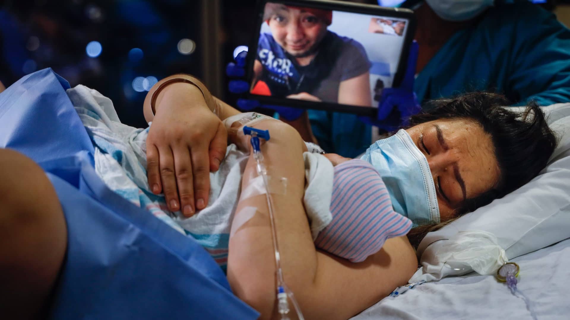 Diana Garcia Garcia holds her baby for the first time as her husband, Manuel Carchipulla, watches via FaceTime in April 2020 in Oceanside, New York.