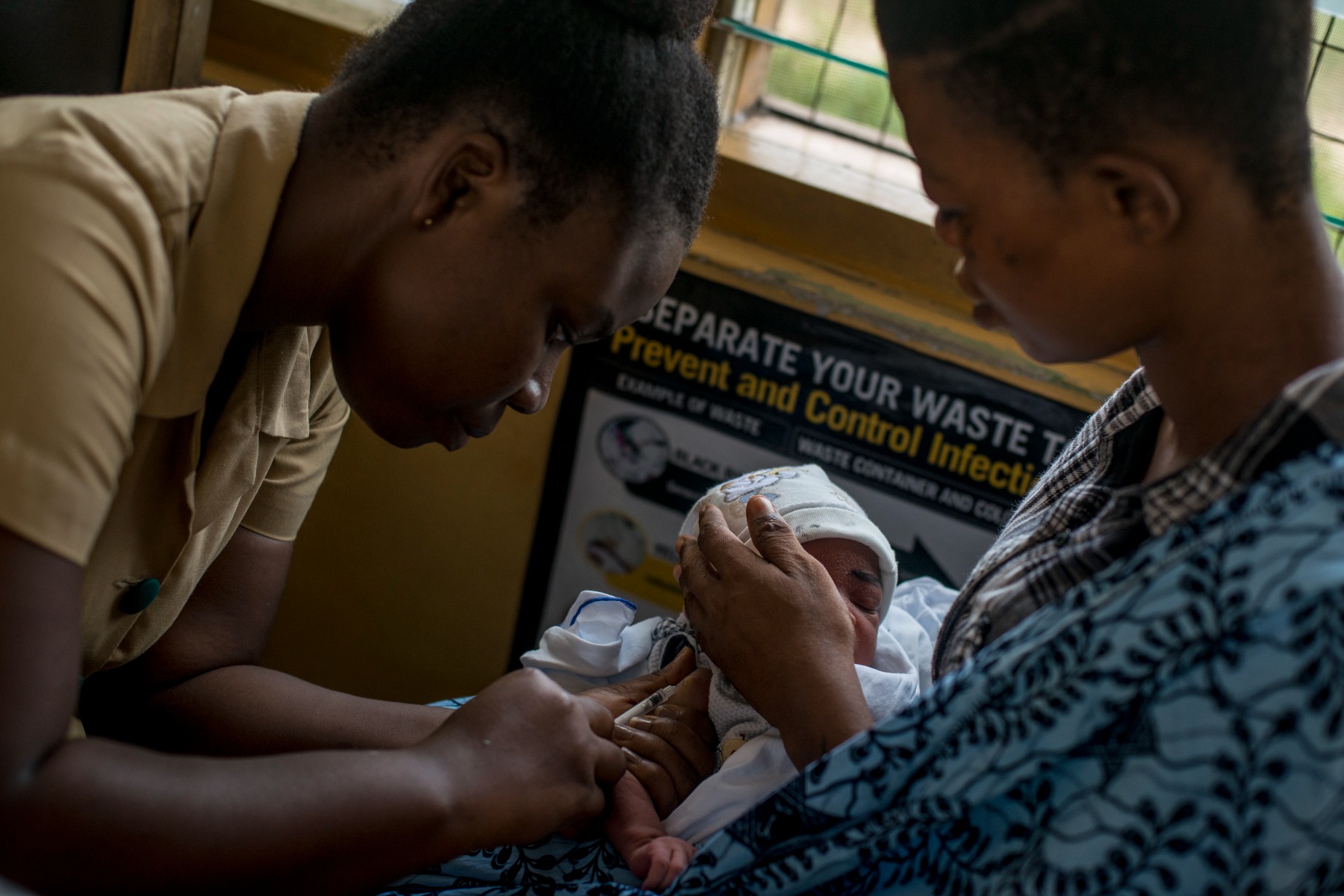 A baby receives vaccine by a nurse at the maternity ward of the Ewin Polyclinic in Cape Coast, Ghana
