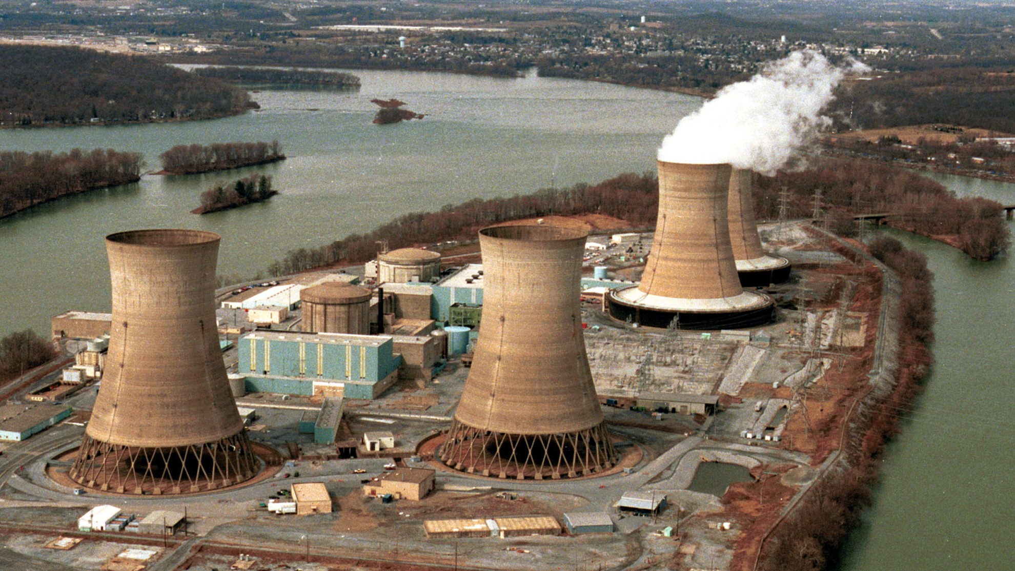 Three Mile Island is seen in the foreground with the damaged reactor
