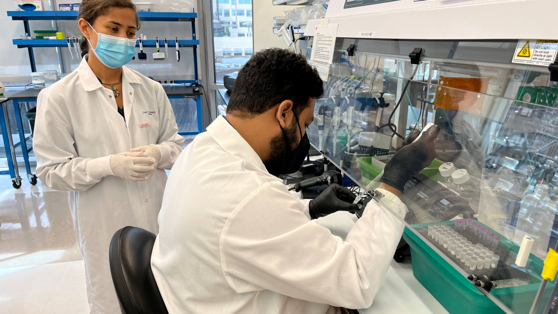 In a mentorship program at the CZ Biohub in San Francisco, Juliana Gil (left) trains researcher Furqan Kabir in sample preparation, sequencing, and using the CZ ID metagenomics platform.