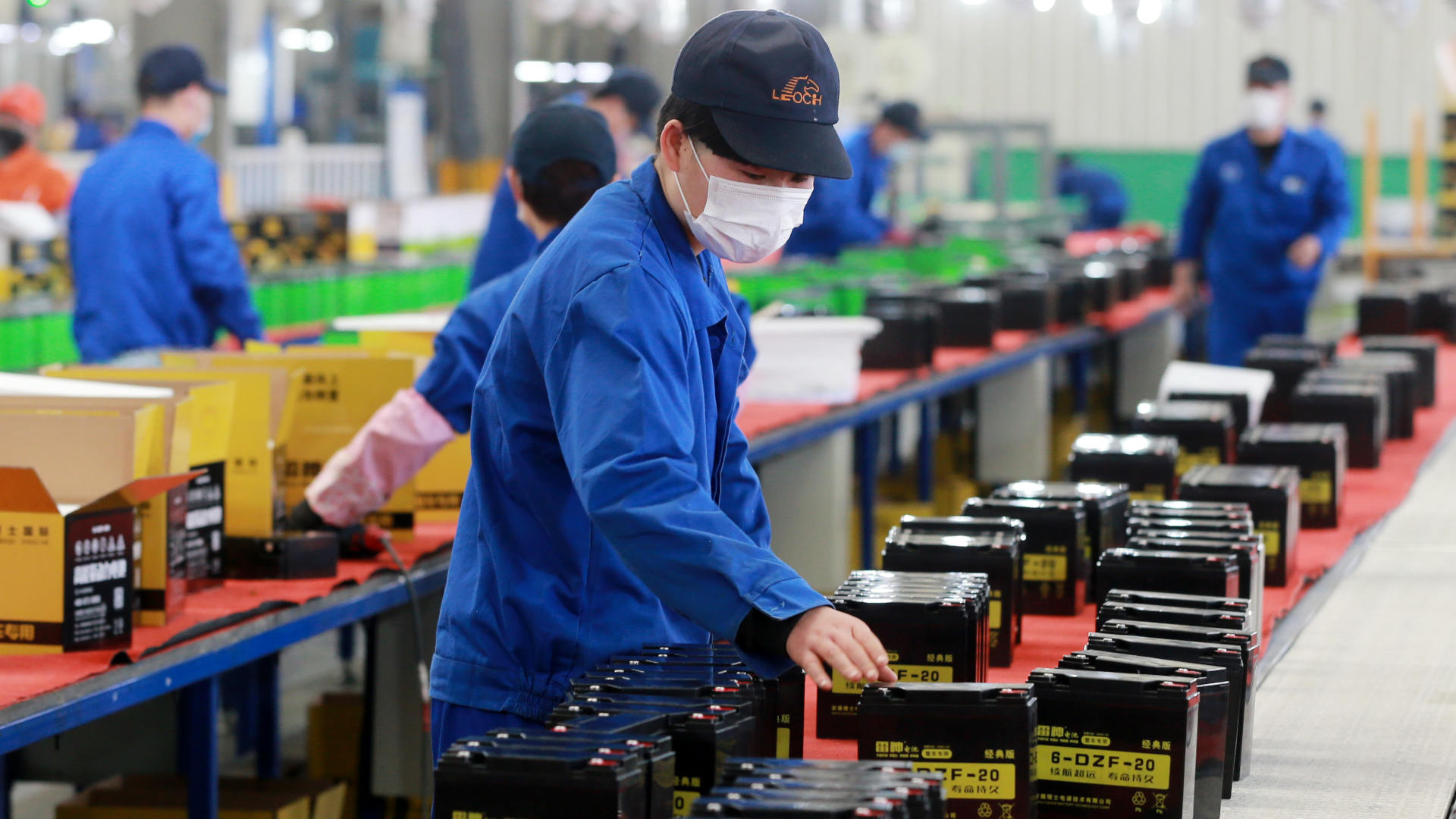 In 2020, masked workers labor in a lead-acid battery factory in central China's Anhui province.