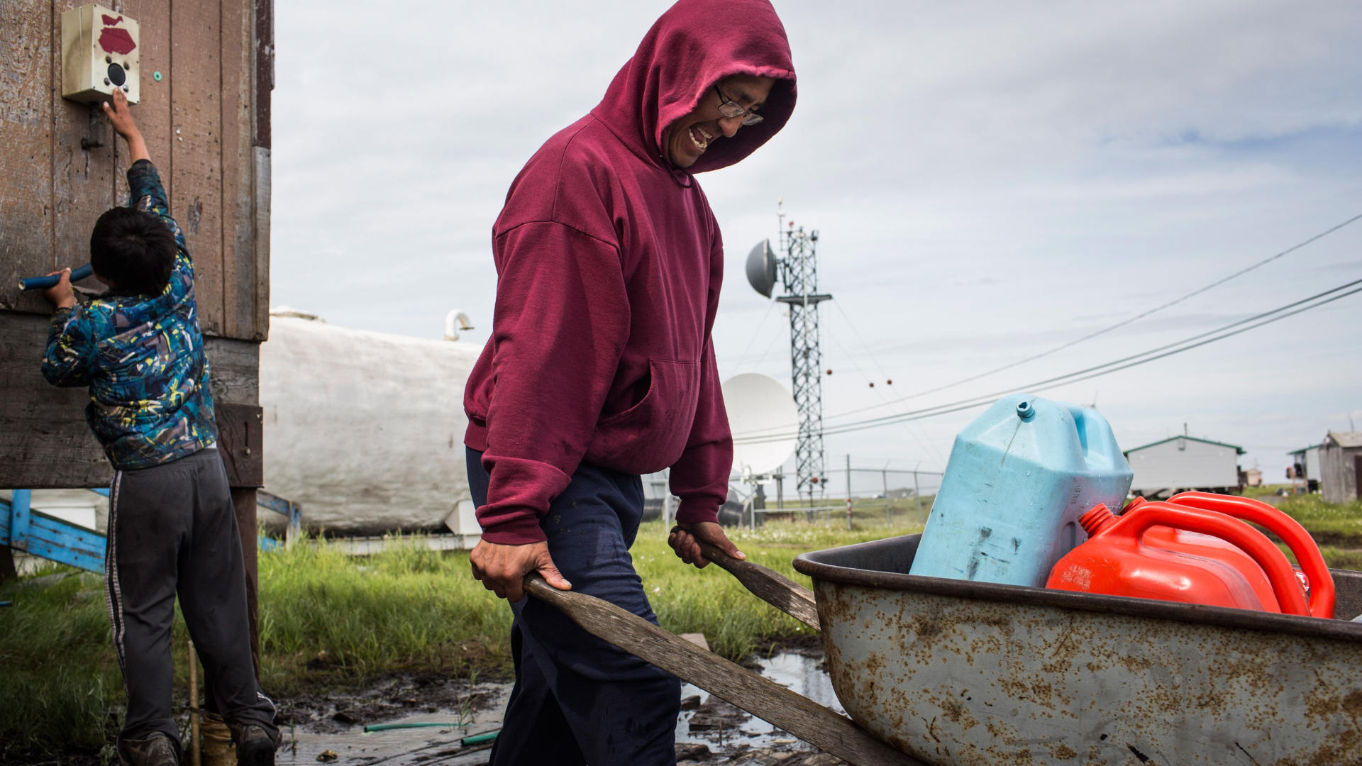 In Newtok, Alaska, Joseph John Jr. collects fresh water for his family in 2015. After decades of planning, most of the town relocated in 2019 due to unlivable conditions caused by climate change.
