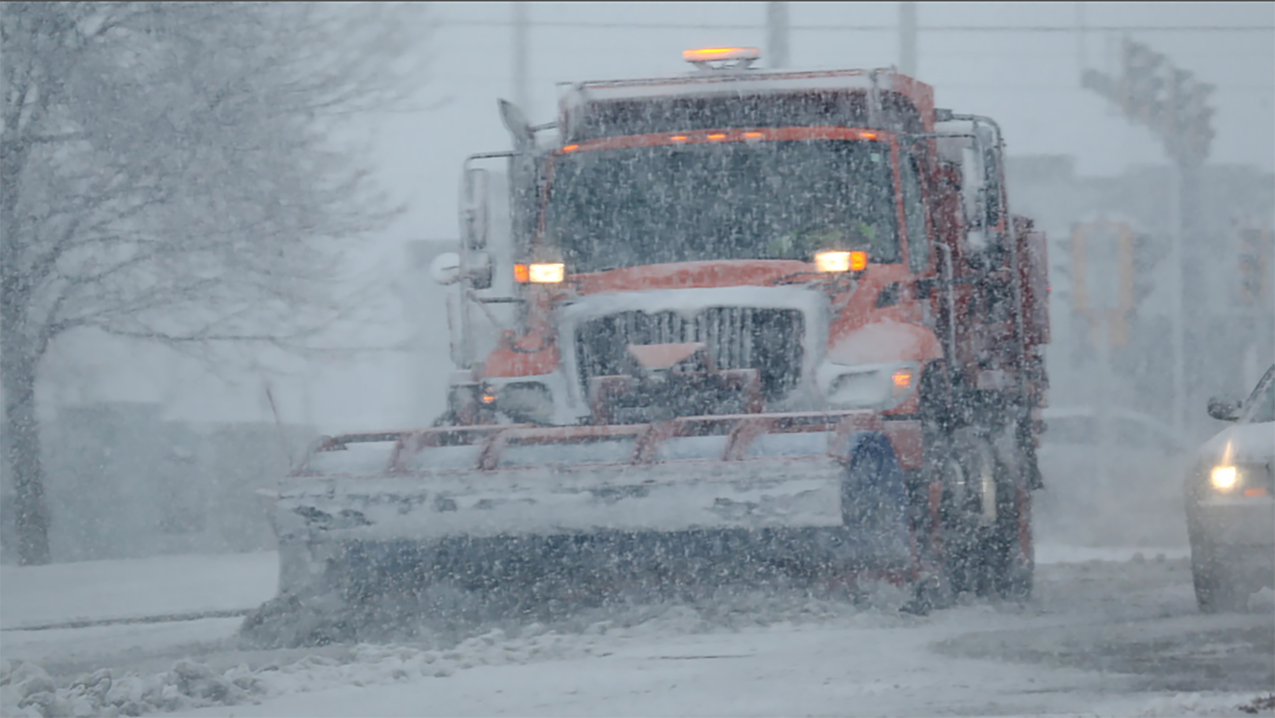 A truck plows and salt roads in Wauwatosa, Wisconsin on Dec. 9, 2022.