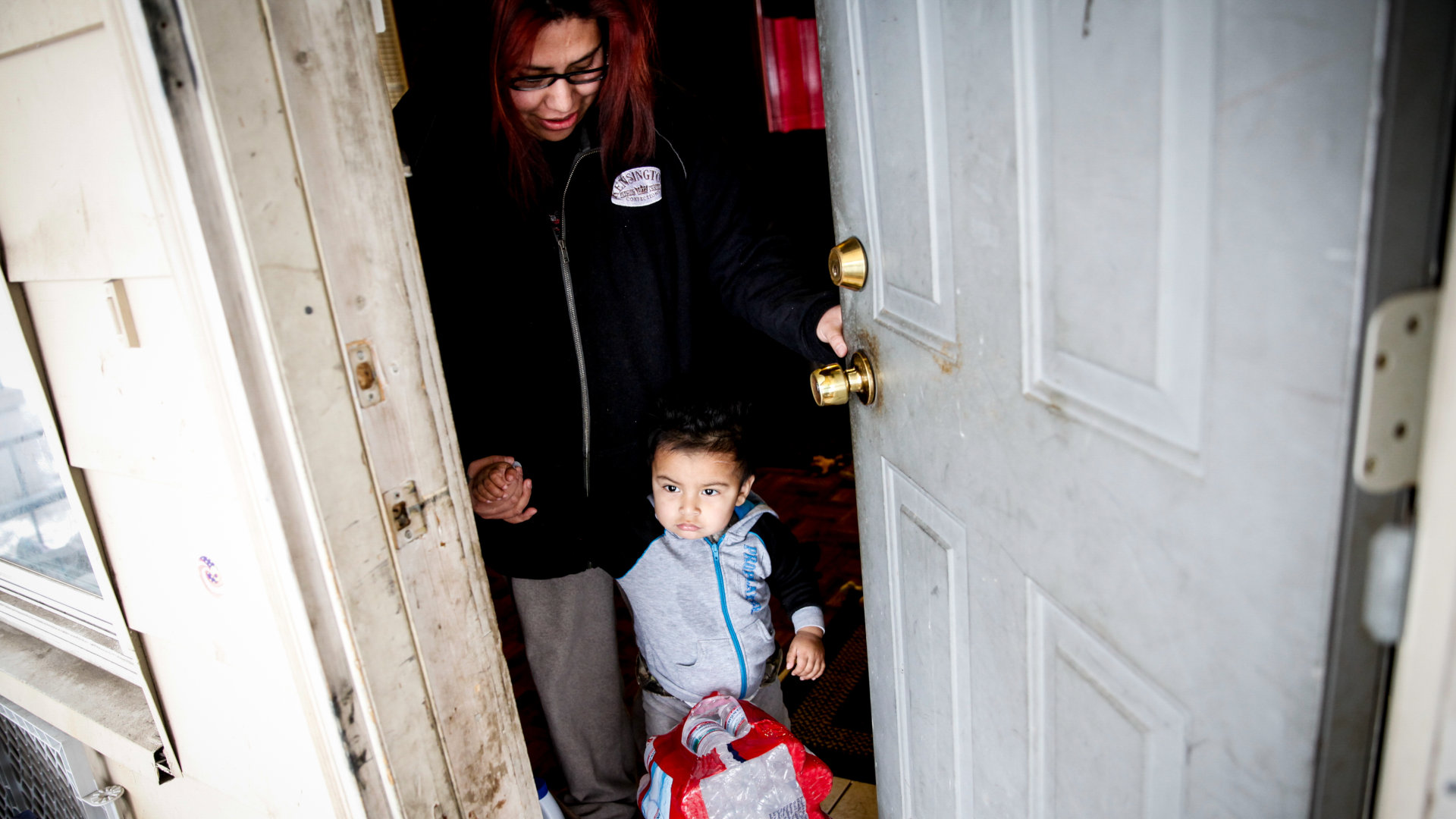 Sandra Mendez and her 1-year-old son receive water from Red Cross volunteers at their home January 21, 2016 in Flint, Michigan.