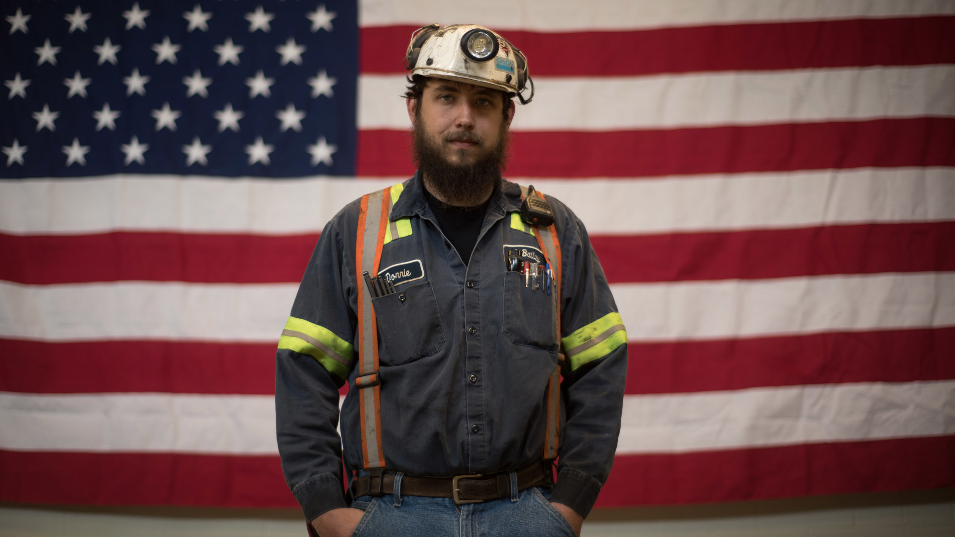 A miner from West Virginia stands in front of an American flag prior to an event with former U.S. EPA Administrator Scott Pruitt at the Harvey Mine in Pennsylvania on April 13, 2017.